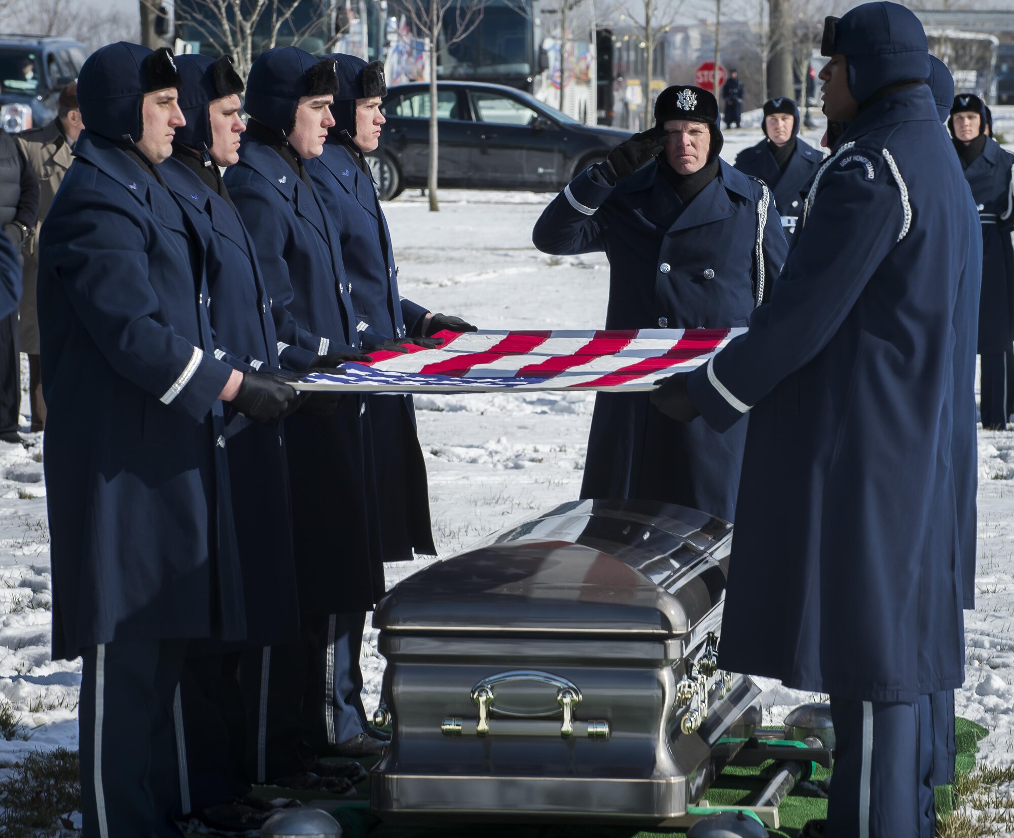 Pall Bearers from the U.S. Air Force Honor Guard fold the flag which draped the casket of Brig. Gen. Robinson "Robbie" Risner during his internment ceremony at Arlington National Cemetery, Arlington, Va., Jan. 23, 2014. Risner was the Air Force's 20th Ace and survived seven and a half years of captivity as a Prisoner of War (POW) in Hoa Lo Prison, a.k.a the Hanoi Hilton, during the Vietnam War. (U.S. Air Force photo/Jim Varhegyi)