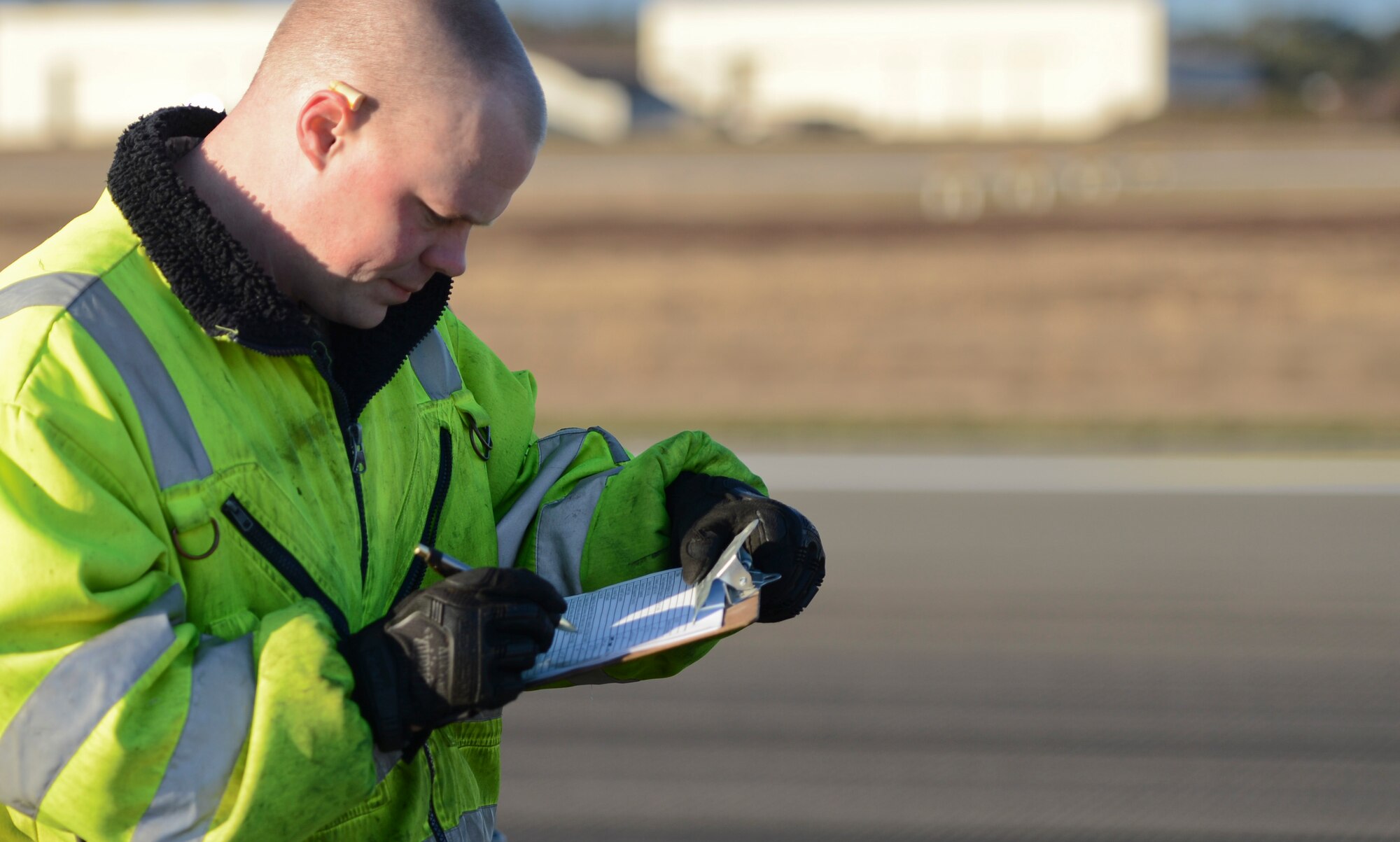 Staff Sgt. Seth Buford, 786th Civil Engineering Squadron power production craftsman, records measurements during a Barrier Arresting Kit-12 test on the flightline Jan. 28, 2014, Ramstein Air Base, Germany. On average, the BAK-12 slows down the aircraft between 650 feet to 850 feet within a few seconds. (U.S. Air Force Photo/Airman First Class Michael Stuart)