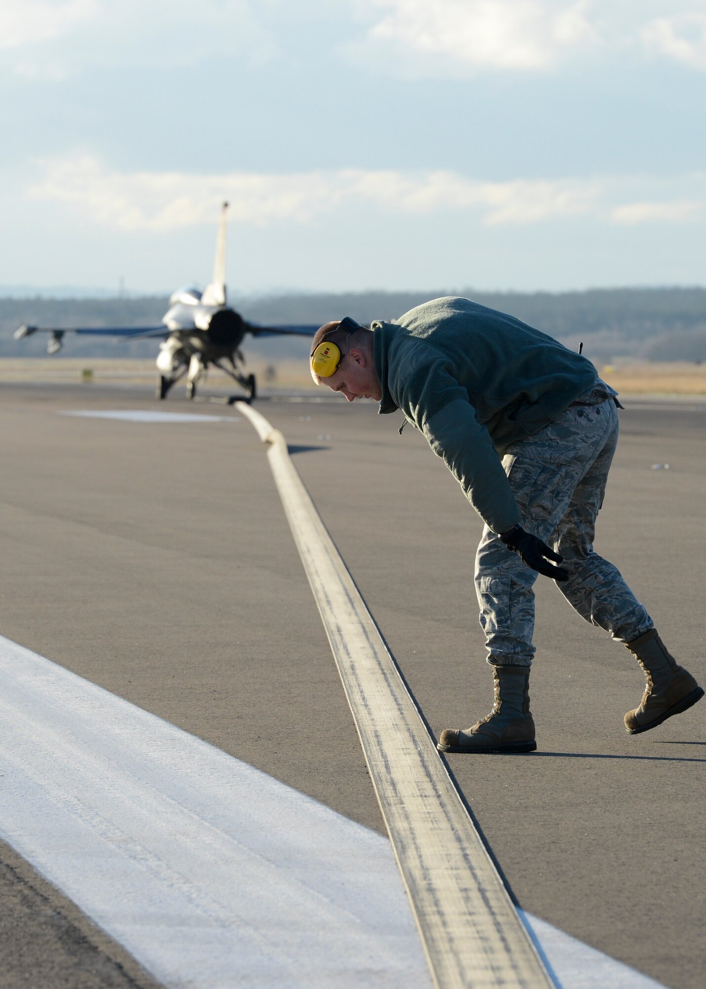 Senior Airman Jared Jones, 786th Civil Engineering Squadron power production journeyman, checks part of a Barrier Arresting Kit-12 for foreign object damage on the flightline Jan. 28, 2014, Ramstein Air Base, Germany. When all else fails and an aircraft is unable to stop on its own, the BAK-12 decelerates the aircraft on the runway, ensuring the pilot and aircraft lands safely. (U.S. Air Force Photo/Airman First Class Michael Stuart)