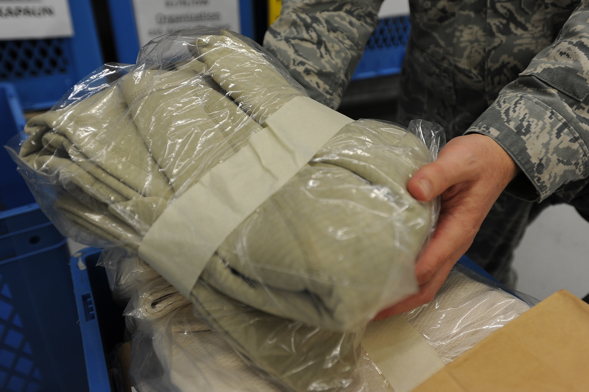 Master Sgt. Kenneth Pruett, 86th Logistics Readiness Squadron unit deployment manager, packs uniforms for a deploying troop Jan. 21, 2014, Ramstein Air Base, Germany. The five UDMs of LRS helped deploy 113 Airmen in 2013 by providing them with the proper training and equipment before leaving.(U.S. Air Force photo/Airman 1st Class Holly Mansfield)