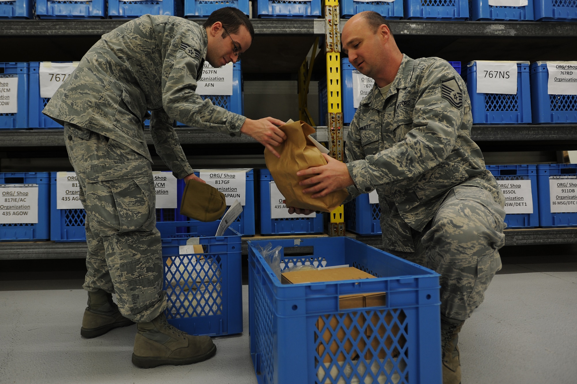 Senior Airman Andrew Mero, 86th Logistics Readiness Squadron individual equipment element technician, and Master Sgt. Kenneth Pruett, 86th LRS unit deployment manager, pack equipment for a deploying troop Jan. 21, 2014, Ramstein Air Base, Germany. UDMs help ensure Airmen have the proper equipment and training before deploying. (U.S. Air Force photo/Airman 1st Class Holly Mansfield)