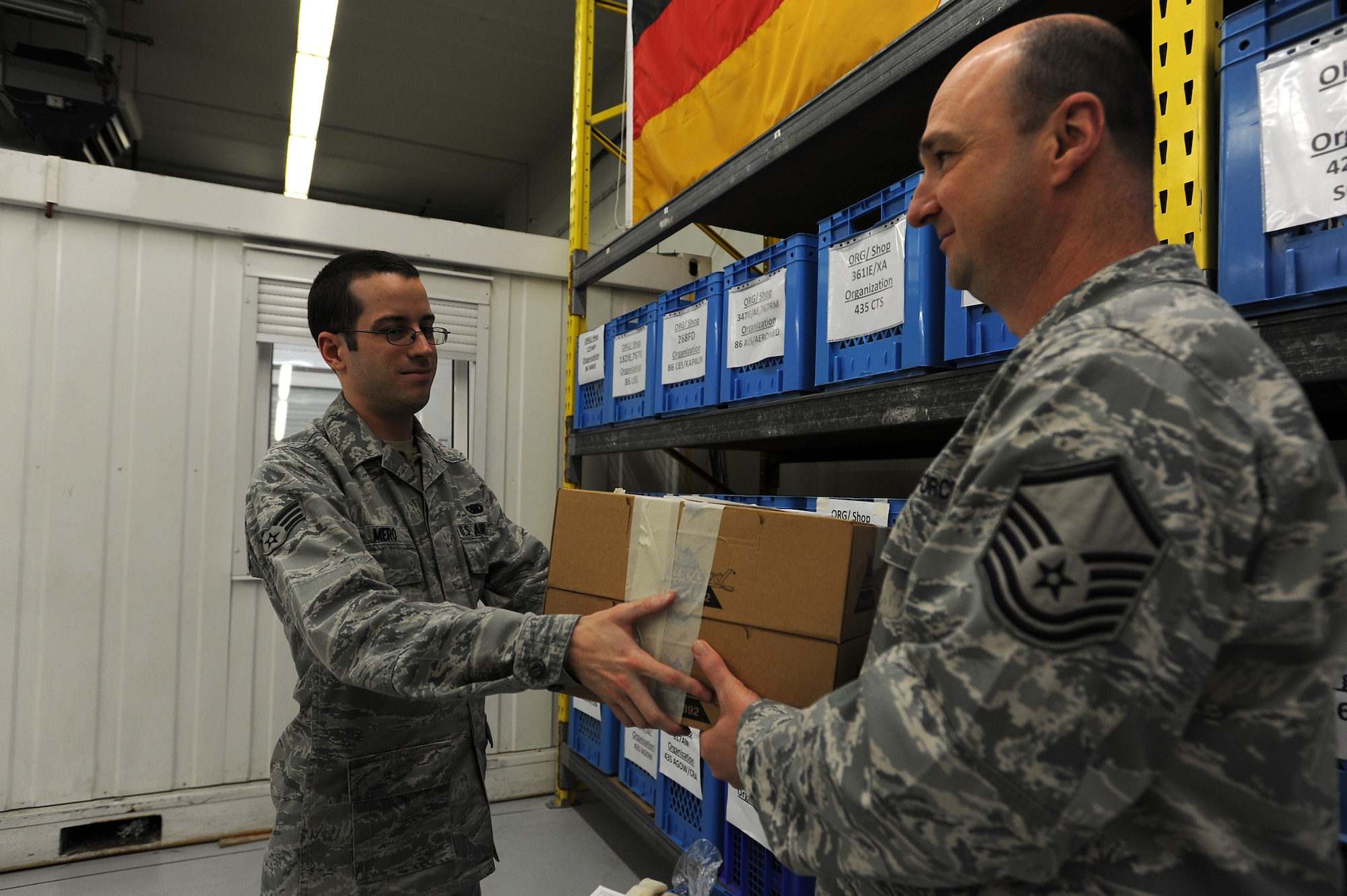 Senior Airman Andrew Mero, 86th Logistics Readiness Squadron individual equipment element technician, issues Master Sgt. Kenneth Pruett, 86th LRS unit deployment manager, boots for a deploying troop Jan. 21, 2014, Ramstein Air Base, Germany. Pruett is one of five UDMs who help insure the 376 military members of LRS are mission ready before deploying. (U.S. Air Force photo/Airman 1st Class Holly Mansfield)
