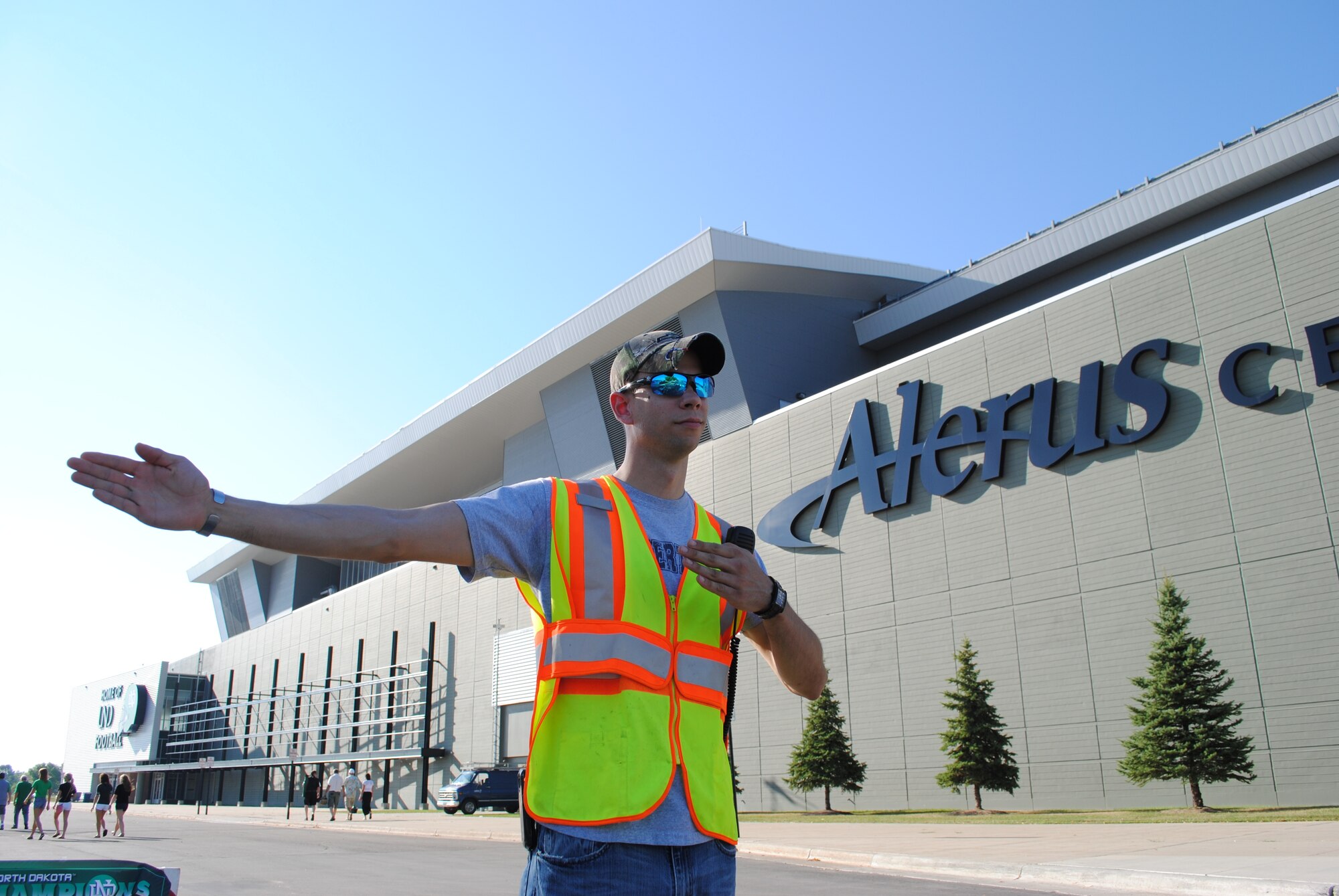 Staff Sgt. Christopher Giles, 319th Security Forces Squadron training instructor, volunteers for parking detail during Military Appreciation Day activities Aug. 29, 2013, at the Alerus Center in Grand Forks, N.D. Giles also volunteered to help troubled teens by being a mentor in the Big Brother Program for the YMCA of Grand Forks. (U.S. Air Force photo/Staff Sgt. Luis Loza Gutierrez)