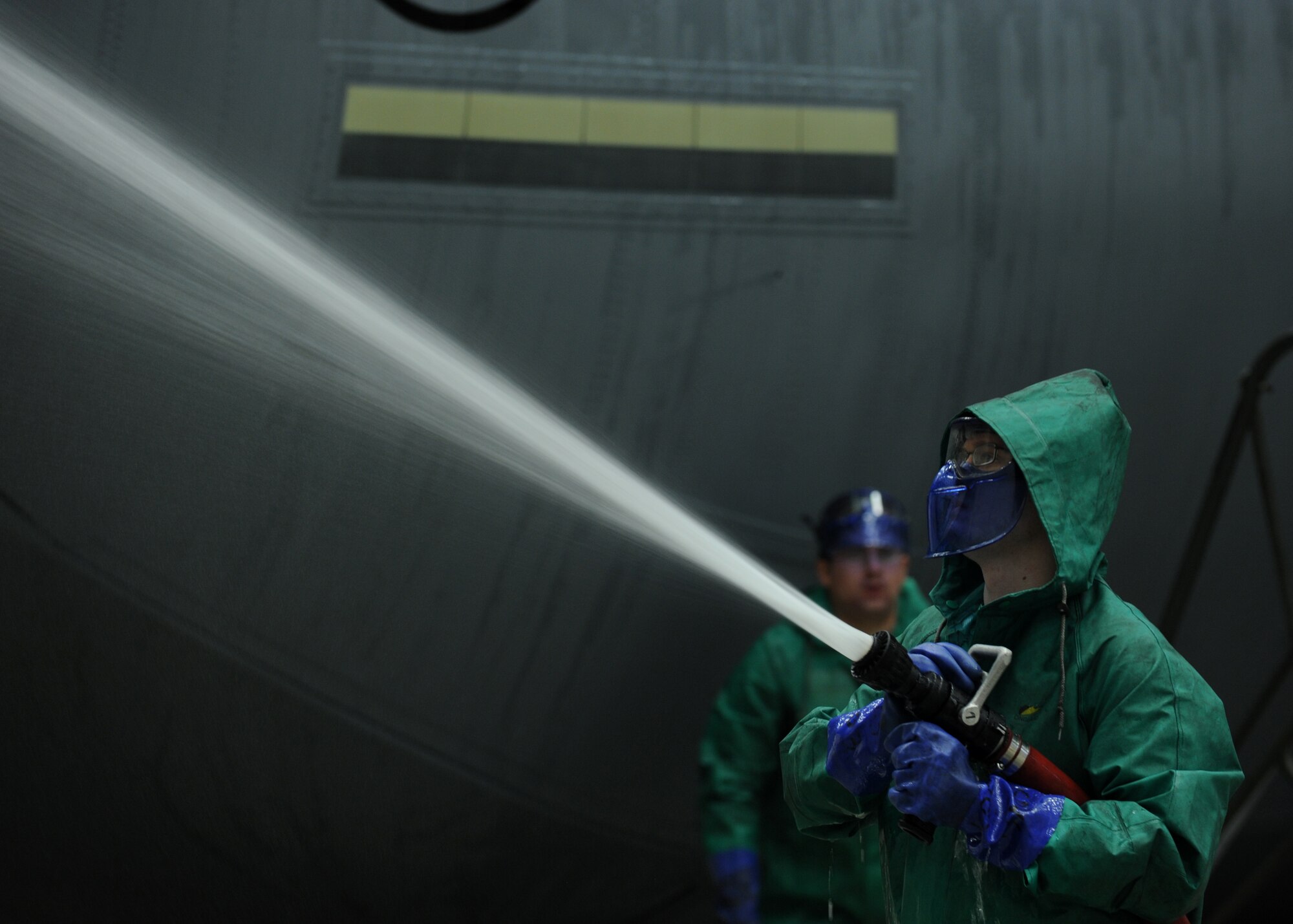 An Airman from the 19th Aircraft Maintenance Squadron rinses the tail wing of a C-130J Jan. 23, 2014, at Little Rock Air Force Base, Ark. Dirt, grease, grime, exhaust carbon and hydraulic oils can hide cracks or other faults with an aircraft and must be washed before an isochronal inspection. (U.S. Air Force photo by Airman 1st Class Scott Poe)