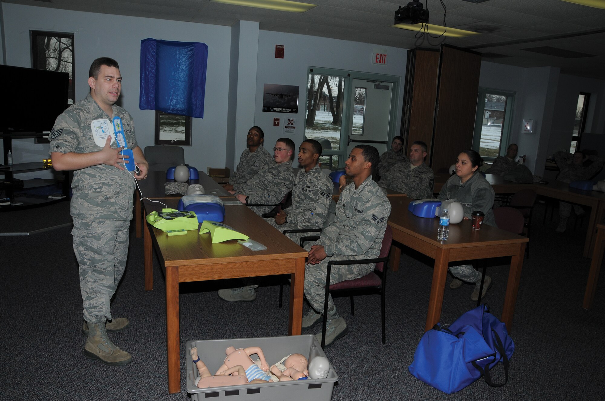 WRIGHT-PATTERSON AIR FORCE BASE, Ohio - Staff Sgt. Steven Flowers, 445th Aerospace Medicine Squadron NCO in charge of cardiopulmonary respiratory, teaches 14 Airmen assigned to the 445 AMDS, 445th Civil Engineering Squadron and 445th Force Support Squadron proper CPR techniques during the Jan. 5, 2014 unit training assembly. The Airmen were taught resuscitation methods on a mannequin by giving breaths, two-inch deep chest compressions and with the automated external defibrillator. The training was held as part of a bi-annual medical education requirement. (U.S. Air Force photo/Tech. Sgt. Anthony Springer)