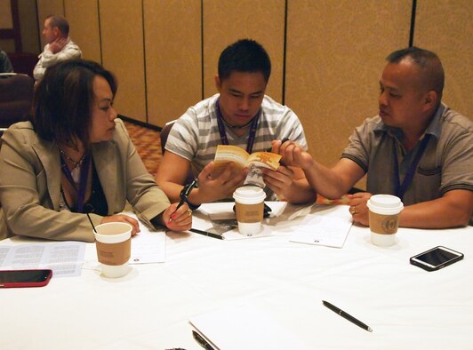 INDIAN WELLS, Calif. -- Airman 1st Class Donel Pascual (center), an Air Force reservist with the 433rd Airlift Wing, Lackland Air Force Base, Texas, discusses deployment benefits with his father, retired Army Lt. Col. Madonel Pascual (right), and mother, Susie Pascual, during Air Force Reserve Command's Yellow Ribbon event Jan. 26, 2014 in Indian Wells. Airman Pascual will be deploying to Kyrgyzstan in the spring. AFRC’s Yellow Ribbon program provides information, services, referral and proactive outreach programs to Reservists and their families through all phases of deployment cycles. (U.S. Air Force photo/Tech. Sgt. Anna-Marie Wyant)