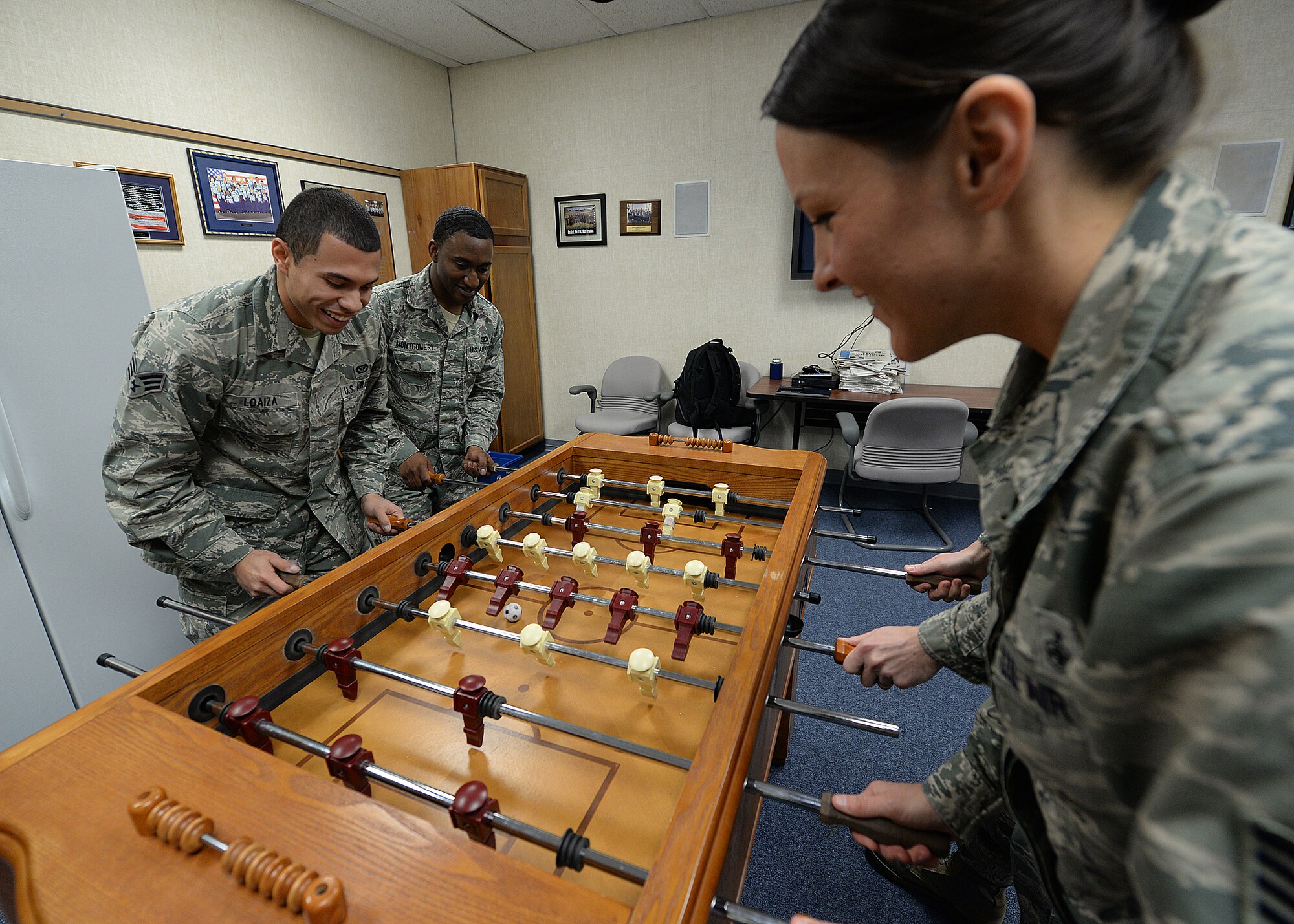 ALTUS AIR FORCE BASE, Okla. – Airman Leadership School instructors and students play foosball after a lecture in the Airman Leadership School break room Jan. 28, 2014. The instructors and students use their leisure time playing foosball and ping pong after long sessions of class work. (U.S. Air Force photo by Senior Airman Levin Boland/Released)