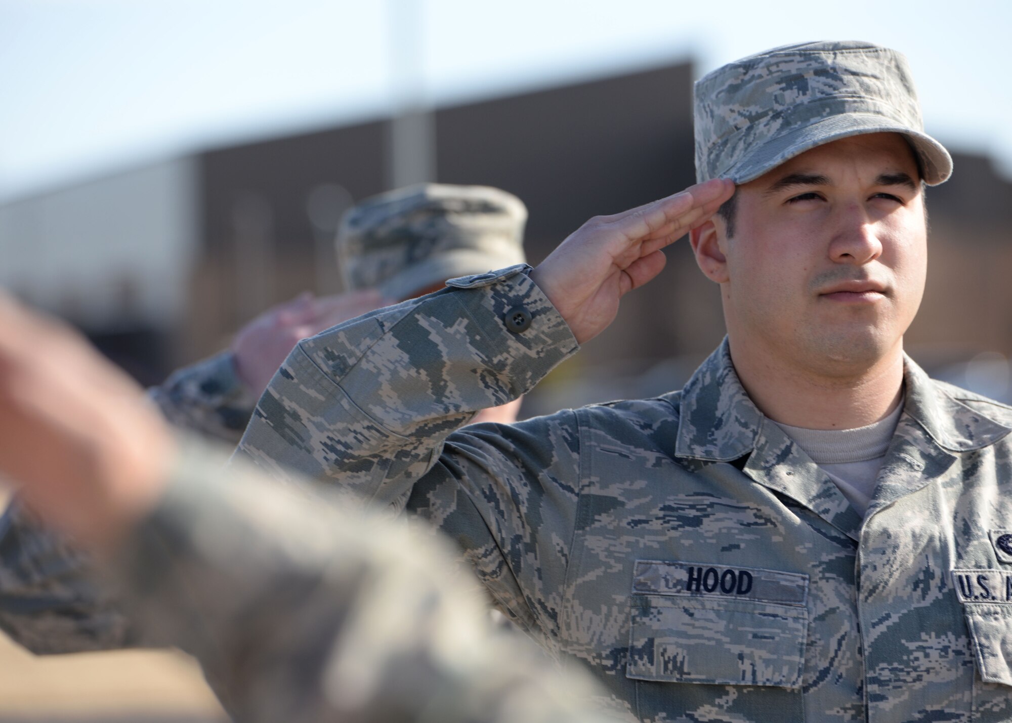 ALTUS AIR FORCE BASE, Okla. – U.S. Air Force Senior Airman Jeremy Hood, 97th Logistics Readiness Squadron, salutes while standing in formation at the Airman Leadership School parade training area Jan. 15, 2014. During ALS, Airmen hone their knowledge of military customs and courtesies and learn to become more effective leaders by supervising Airmen and becoming better communicators. (U.S. Air Force photo by Senior Airman Levin Boland/Released)