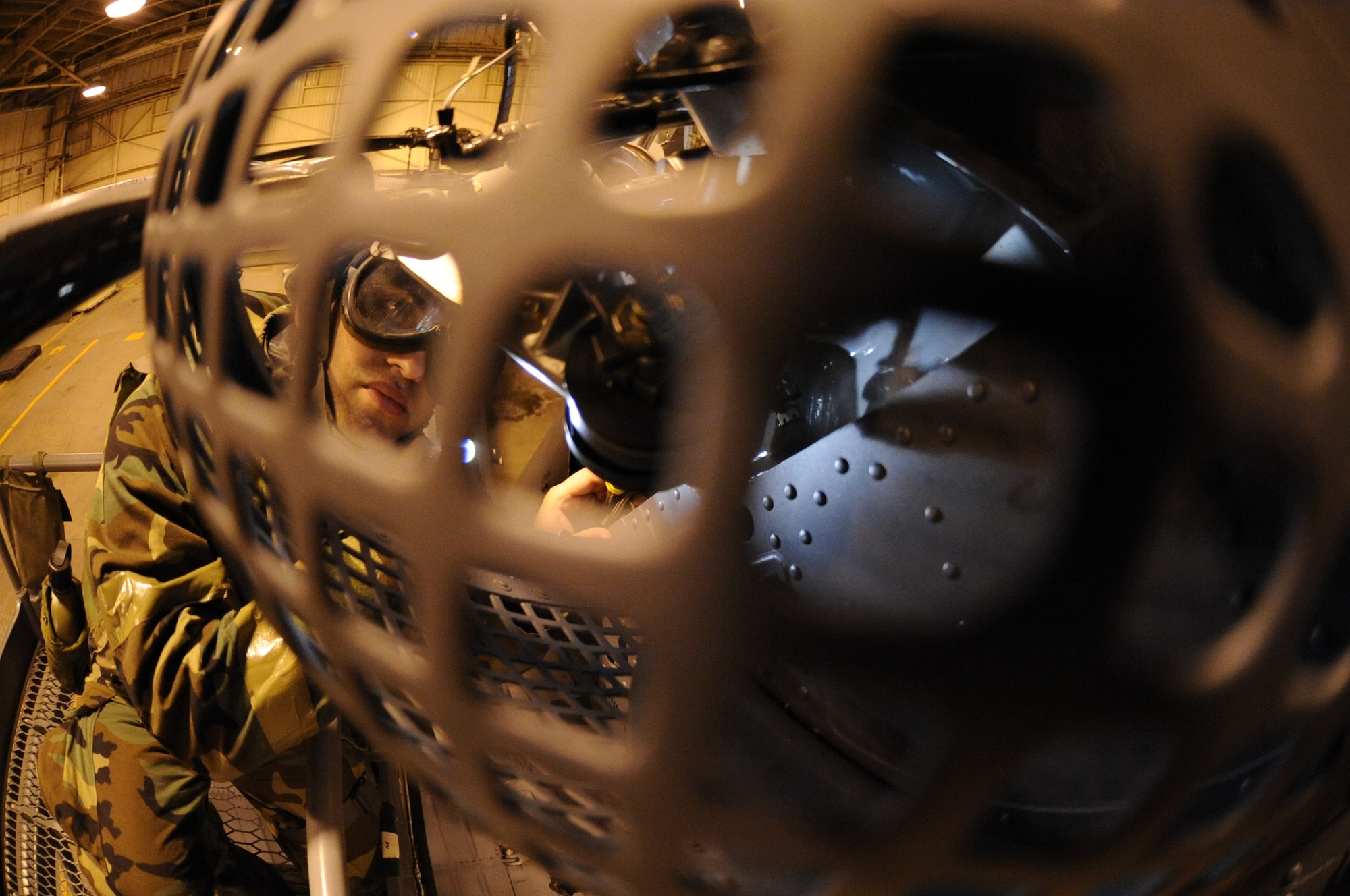 U.S. Air Force Airman 1st Class Cody Garcia, 33rd Helicopter Maintenance Unit crew chief, inspects a tail gear box and servos for leakage and foreign objects on an HH-60G Pave Hawk helicopter on Kadena Air Base, Japan, Jan. 30, 2014. The HH-60 is capable of performing civil search and rescue, emergency aeromedical evacuation, disaster relief, and international aid. (U.S. Air Force photo by Airman 1st Class Keith James)