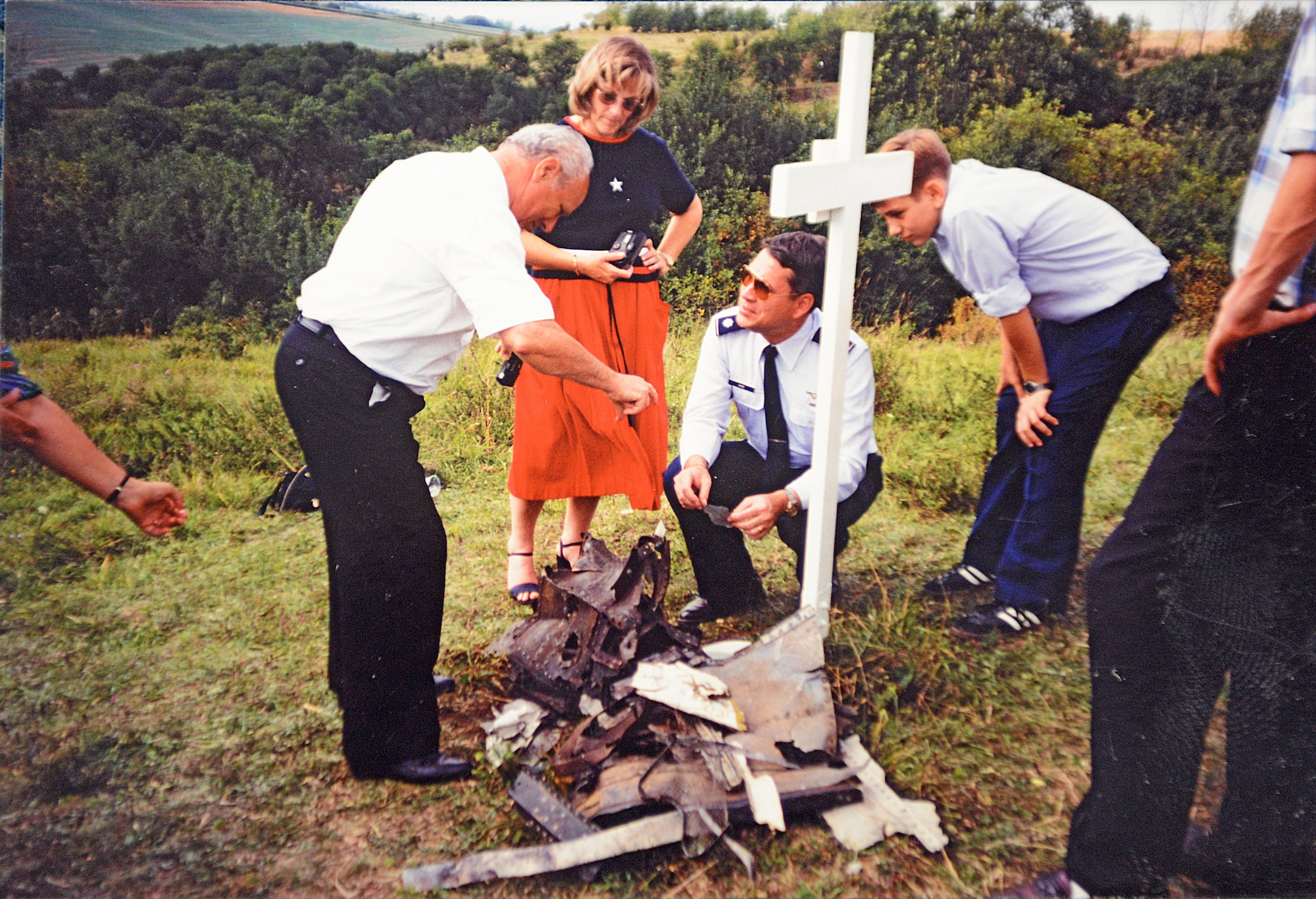 Lt. Col. Monty Hand (center kneeling), U.S. Air Forces in Europe, meets with the brothers who discovered the crash site in Vogelsberg, Germany. Now retired, Mr. Monty Hand returned to the memorial to celebrate the 50th anniversary of the crash.  (Courtesy Photo)