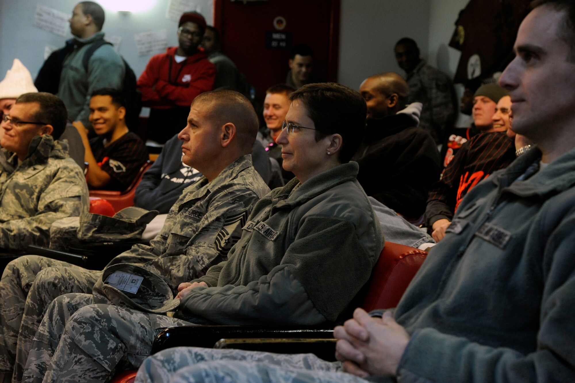 Maj. Gen. Theresa C. Carter, Air Force civil engineer, and Chief Master Sgt. Jerry Lewis, chief of Enlisted Matters of the Air Force Civil Engineer, watch a Sexual Assault Theater Group skit during their visit to Kunsan Air Base, Republic of Korea, Jan. 29, 2013. The Kunsan SAT-G is a unique tool used to educate Airmen about combatting sexual assault. The general visited the Wolf Pack to learn more about the base's mission and capabilities. Carter and Lewis toured Kunsan to get a hands-on view of the mission, as well as to hear Airmen’s concerns and answer questions they may have. (U.S. Air Force photo by Staff Sgt. Jessica Haas/Released)