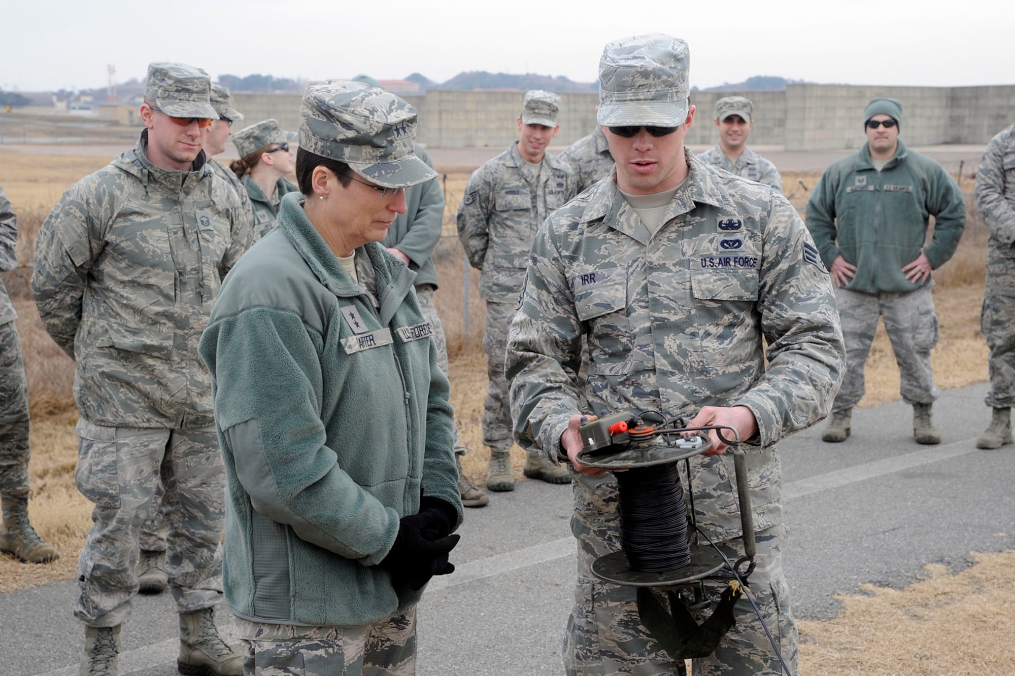 Maj. Gen. Theresa C. Carter, the Air Force civil engineer, is briefed by Senior Airman Kyle Irr, 8th Civil Engineer Squadron explosive ordinance disposal technician, on how to activate a fueled explosive device for a training scenario during her visit to Kunsan Air Base, Republic of Korea, Jan. 29, 2013. Carter toured Kunsan to get a hands-on view of the mission, as well as to hear Airmen’s concerns and answer questions they may have. (U.S. Air Force photo by Staff Sgt. Jessica Haas/Released)