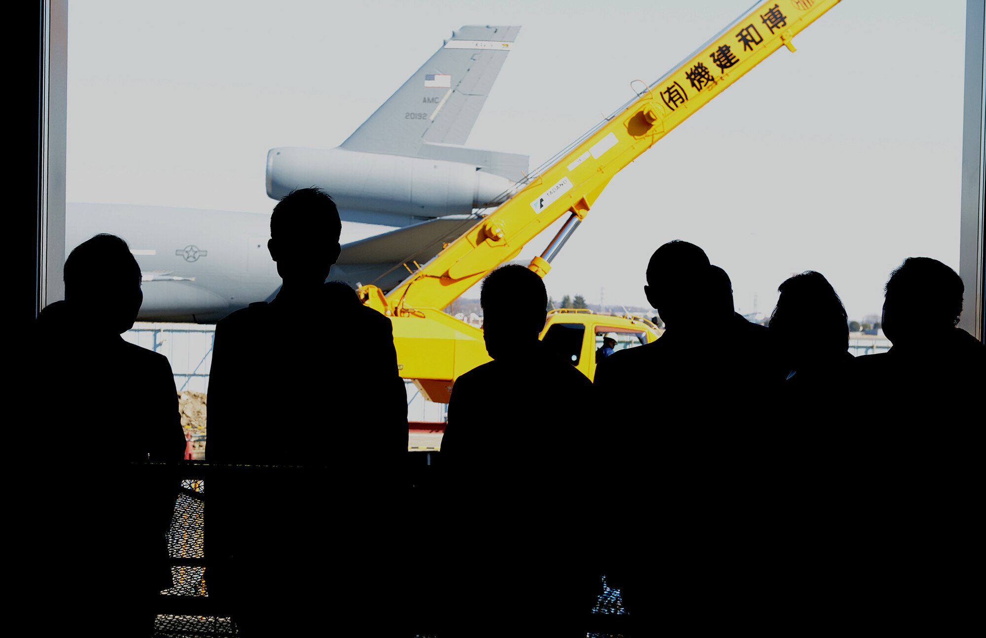 Members of the Vice Mayors Council look at a KC-10 Extender from Travis Air Force Base during a guided tour at Yokota Air Base, Japan, Jan. 29, 2014. The tour focused on Yokota’s ability to provide tactical and strategic airlift support. (U.S. Air Force photo by Airman 1st Class David Danford/Released)