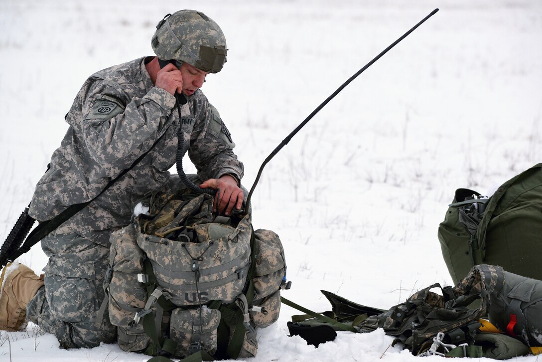 A U.S. Army paratrooper conducts a radio check after completing a training jump from a C-130 Hercules aircraft on Grafenwoehr Training Area, Germany, Jan. 29, 2014.