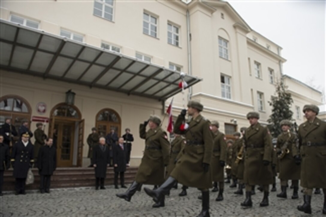 U.S. Defense Secretary Chuck Hagel, left, and Polish Defense Minister Tomasz Siemoniak review troops at the Ministry of National Defense in Warsaw, Poland, Jan. 30, 2014. Hagel is on a trip to Europe to meet with defense leaders and attend the 50th Munich Security Conference.