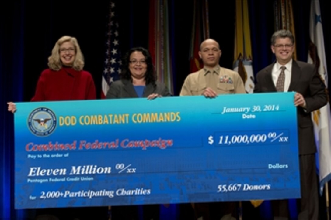 Acting Deputy Defense Secretary Christine H. Fox, left, and Michael L. Rhodes, far right, director of Pentagon administration and management, present the award for $11 million in donations at the awards ceremony for the Combined Federal Campaign at the Pentagon, Jan. 30, 2014. Fox thanked the awardees and participants for their hard work and donations to the more than 4,000 charities that benefit from the campaign.
