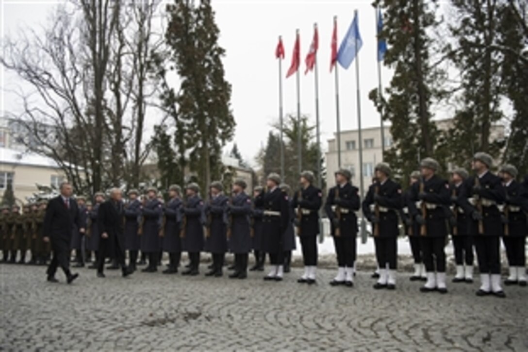 U.S. Defense Secretary Chuck Hagel, right, and Polish Defense Minister Tomasz Siemoniak review troops at the Ministry of National Defense in Warsaw, Poland, Jan. 30, 2014. Hagel is on a trip to Europe to meet with defense leaders and attend the 50th Munich Security Conference.
