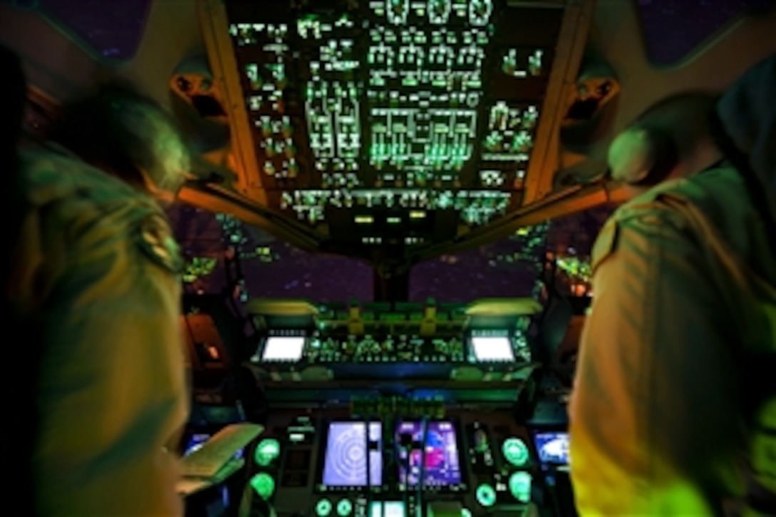 U.S. Air Force Capt. Lauren Hoyt and U.S. Air Force 1st Lt. Mark Benischeck fly a C-17 Globemaster III aircraft over southern Afghanistan, Jan. 25, 2014. Hoyt and Benischeck are pilots assigned to the 816th Expeditionary Airlift Squadron. The crew landed on Kandahar Airfield to airlift mine-resistant, ambush-protected vehicles out of Afghanistan as part of Operation Enduring Freedom retrograde operations.