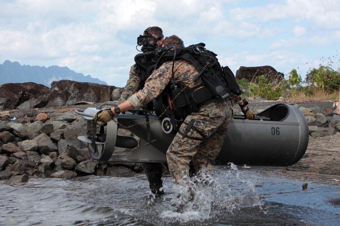 Cpl. Peter E. Kober, left, and Sgt. Scott A. Hulsizer carry their diver propulsion device  into the water to begin their dive Jan. 22, during a certification course at Marine Corps Base Kaneohe Bay, Hawaii. The DPD is a battery-powered vehicle capable of carrying two divers and their equipment while submersed out of sight. The course was a part of Exercise Sandfisher 2014. Kober and Hulsizer are reconnaissance men with Company B, 3rd Reconnaissance Battalion, 3rd Marine Division, III Marine Expeditionary Force. Photo by Cpl. Brandon Suhr