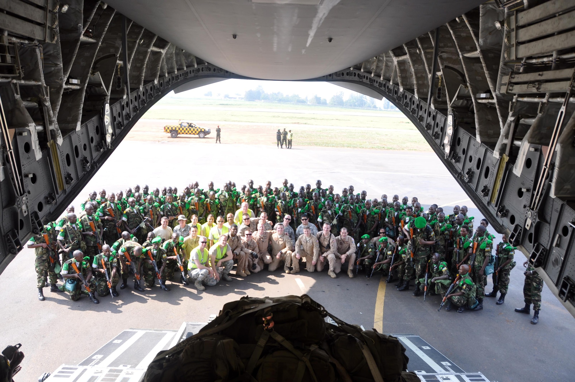 Members of the 435th Contingency Response Element pose with Rwandan soldiers outside a C-17 Globemaster III Jan. 19, 2014, at Kigali International Airport, Rwanda, while supporting peace keeping operations in the Central African Republic.  Airmen from the 435th Air Ground Operations Wing’s Contingency Response Group responded to a request from France and the African Union for U.S. support to move Rwandan forces into the region. (Courtesy photo)