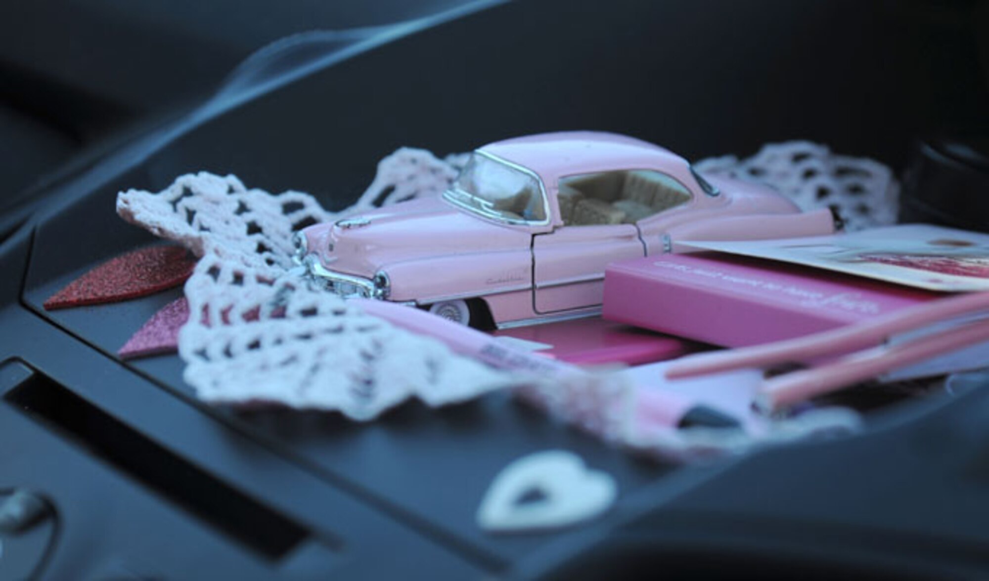 A model vehicle sits on the dashboard of the pink vehicle driven by Alison Miller as she stops for a short break at the Keesler Air Force Base camp site Jan. 16, 2014. Miller is the widow of retired Master Sgt. Chuck Dearing who passed away from cancer last year. Prior to the death of her husband, Miller told him that her intent was to continue traveling in a pink painted car so that he could find her while out on the road. (U.S. Air Force photo/Kemberly Groue)