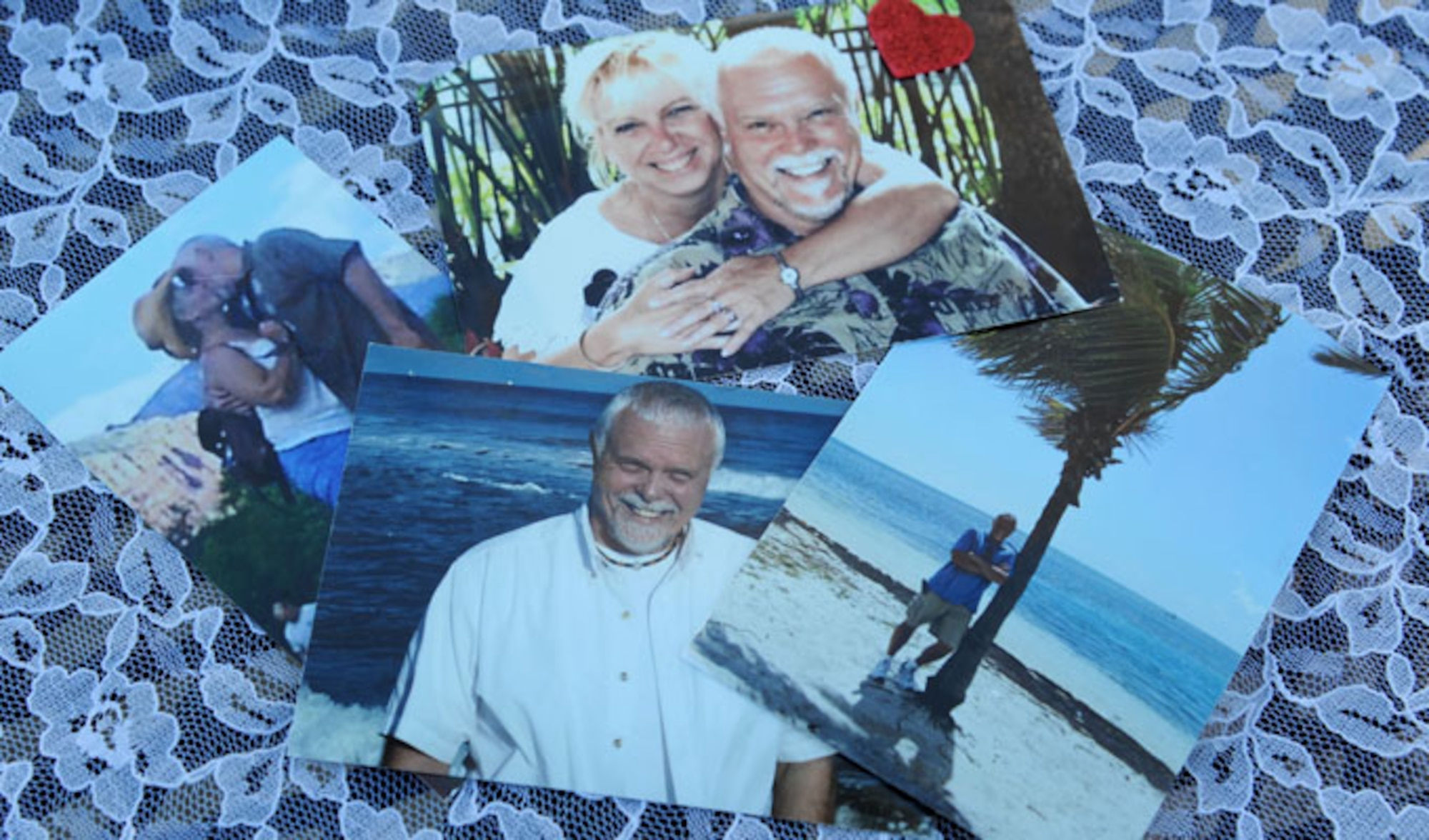A collage of photos of Alison Miller and her late husband, retired Master Sgt. Chuck Dearing, are displayed on a table Jan. 16, 2014, at the Keesler Air Force Base camp site, Biloxi, Miss., while Miller is interviewed for an article about her traveling journey to honor their lives together. Following the couple’s four year cross-country travel experience, Miller continues to travel as she spreads Dearing’s cremains at their favorite destinations. (U.S. Air Force photo/Kemberly Groue)
