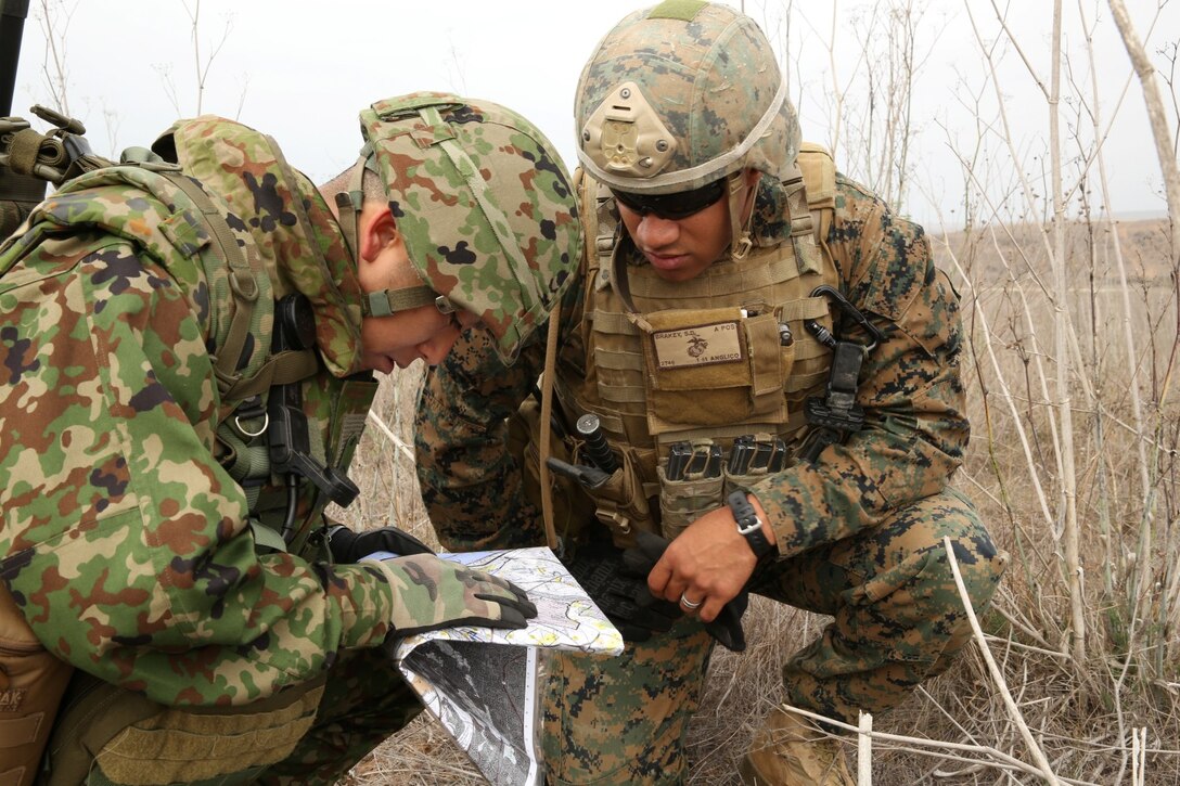 U.S. Marine Cpl. Shawn Brakey, fire-support man, 1st Air Naval Gunfire Liaison Company, helps a soldier with the Japan Ground Self-Defense Force locate points on his map during Exercise Iron Fist 2014 aboard Camp Pendleton, Calif., Jan. 30, 2014. Iron Fist 2014 is an amphibious exercise that brings together Marines and sailors from the 15th Marine Expeditionary Unit, other I Marine Expeditionary Force units, and soldiers from the JGSDF, to promote military interoperability and hone individual and small-unit skills through challenging, complex and realistic training. (U.S. Marine Corps photo by Lance Cpl. Anna K. Albrecht/Released)