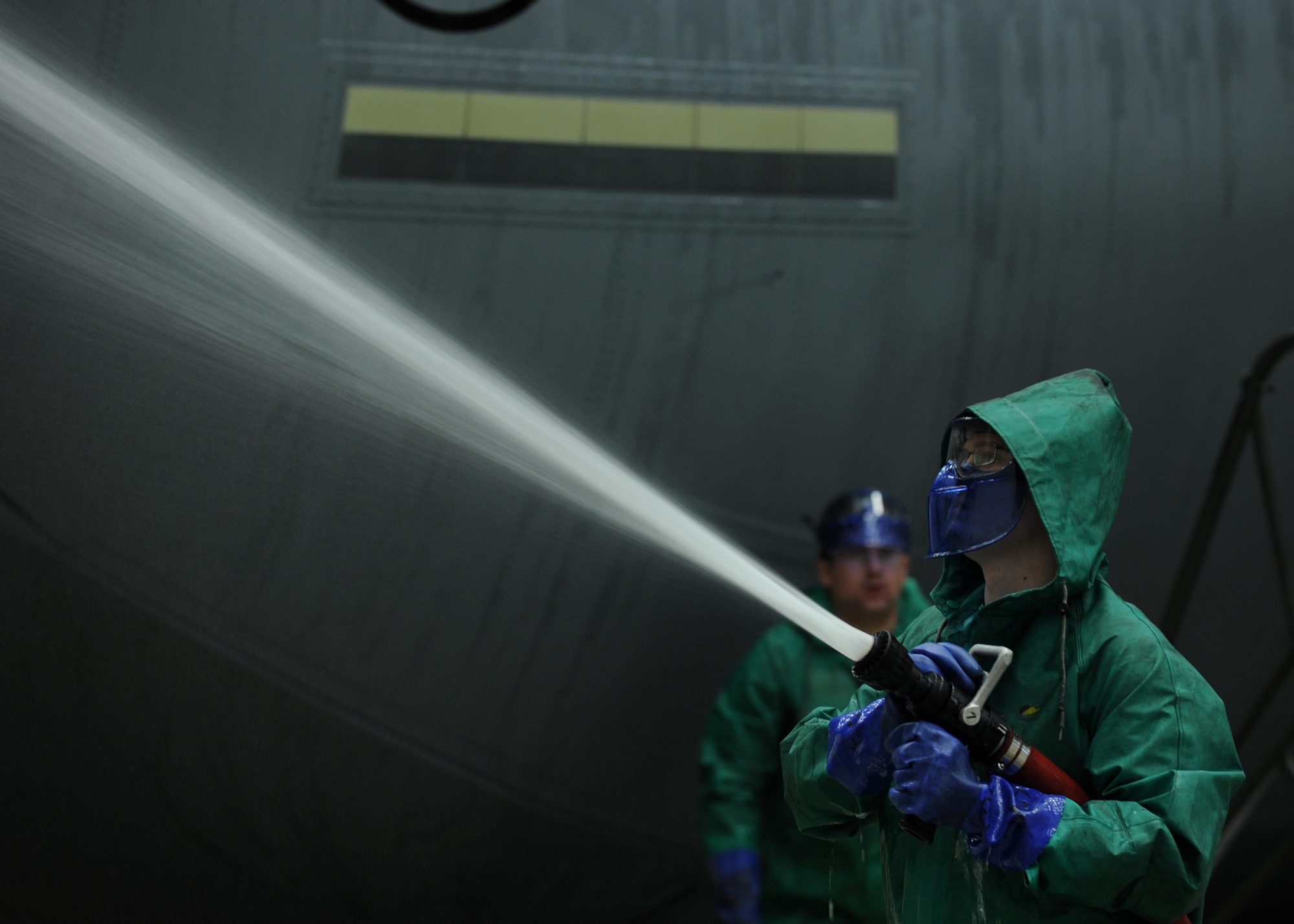 An Airman from the 19th Aircraft Maintenance Squadron rinses the tail wing of a C-130J Hercules Jan. 23, 2014, at Little Rock Air Force Base, Ark. Dirt, grease, grime, exhaust carbon and hydraulic oils can hide cracks or other faults on an aircraft and must be washed before an isochronal inspection. (U.S. Air Force photo/Airman 1st Class Scott Poe) 