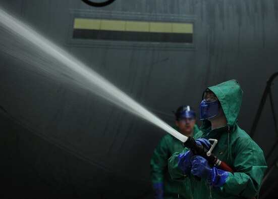 An Airman rinses the tail wing of a C-130J Hercules Jan. 23, 2014, at Little Rock Air Force Base, Ark. Dirt, grease, grime, exhaust carbon and hydraulic oils can hide cracks or other faults on an aircraft and must be washed before an isochronal inspection. The Airman is from the 19th Aircraft Maintenance Squadron. (U.S. Air Force photo/Airman 1st Class Scott Poe) 