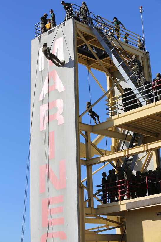 Marines of Company F, 2nd Recruit Training Battalion, make their way up the Rappel Tower to descend the 60-feet down aboard the depot, Jan. 9. There were two ways to rappel down from the tower; the center “hell hole” or on the side of the tower. 