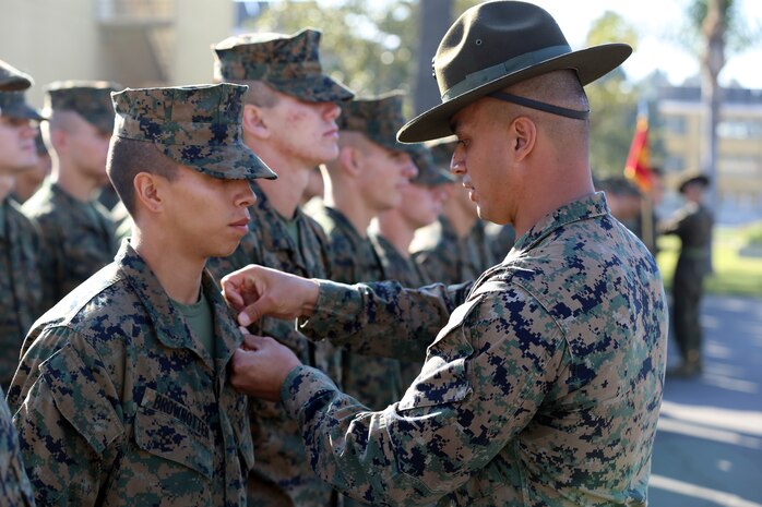 Lance Cpl. Cristian J. Brown-otter, company honorman, Platoon 1042, Company C, 1st Recruit Training Battalion, is meritoriously promoted by Staff Sgt. Scott P. Henryson, senior drill instructor, during a promotion ceremony aboard the depot, Jan. 22. During recruit training, the company honor man is usually meritoriously promoted to the next higher rank.