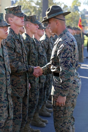 Pfc. Jeremiah C. Sergent, Platoon 1042, Company C, 1st Recruit Training Battalion, shakes hands after being meritoriously promoted by his senior drill instructor, Staff Sgt. Scott P. Henryson, during a promotion ceremony aboard the depot, Jan. 22. Sergent served as a squad leader during recruit training.