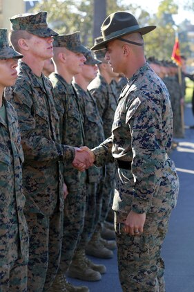 Pfc. Jeremiah C. Sergent, Platoon 1042, Company C, 1st Recruit Training Battalion, shakes hands after being meritoriously promoted by his senior drill instructor, Staff Sgt. Scott P. Henryson, during a promotion ceremony aboard the depot, Jan. 22. Sergent served as a squad leader during recruit training.