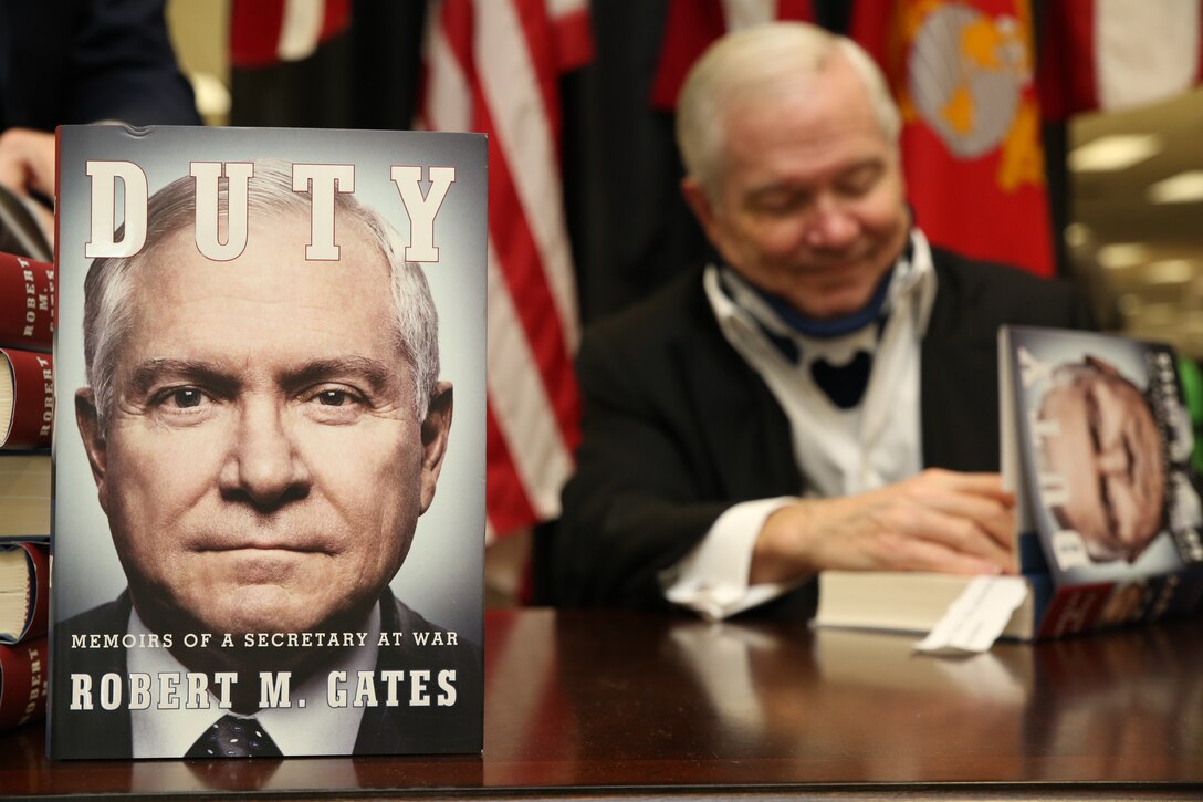 Robert M. Gates, 22nd United States Secretary of Defense and author of Duty: Memoirs of a Secretary at War, signs copies of his newly released book at the Marine Corps Exchange on Marine Corps Base Quantico on Jan. 17, 2014. Nearly 1,000 copies were sold in two days at the exchange.