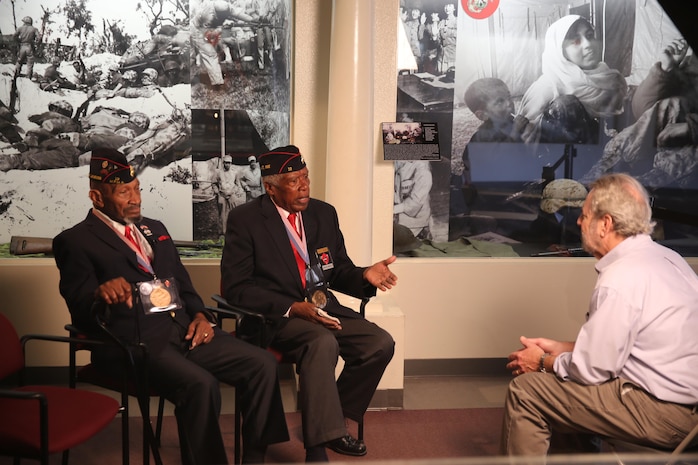 Montford Point Marines (left to right) Joe Jackson and J.T Inge tell their story to a KBPS reporter in the Command Museum aboard the depot, Jan. 24.  Jackson and Inge, who both currently reside in San Diego, attended the original segregated recruit training depot, Camp Montford Point, Jacksonville, N.C. in 1943 and 1946.