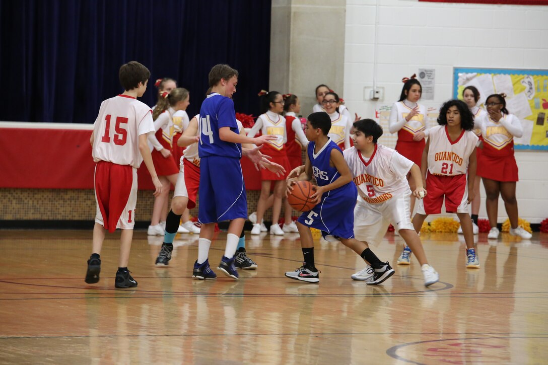 Quantico Middle School Warriors basketball players keep their defense tight during their game against the Dahlgren Middle School Tigers on Jan. 14, 2014. Their efforts led them to a 54-22 win.