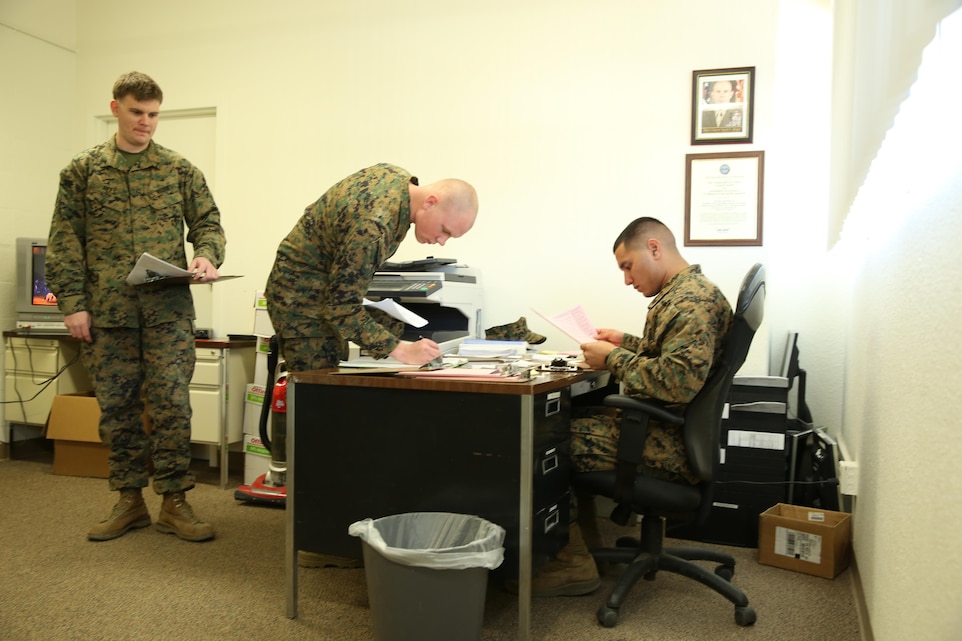 Pfc. Anthony Maldanado, tax preparer, Combat Center Tax Center, assists a Marine with his forms before assigning them to a specific preparer at the Tax Center, Jan. 28, 2014. Tax center staff are certified with the Internal Revenue Service and know military deductions Marines can utilize.