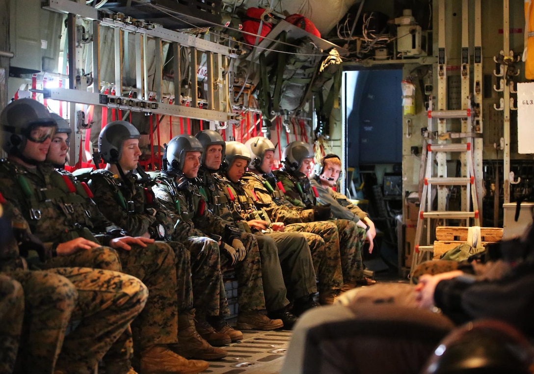 Reconnaissance Marines from 3rd Reconnaissance Battalion, 3rd Marine Division, sit inside a Lockheed C-130 Hercules aircraft to conduct high-attitude high-opening parachuting during Exercise Sandfisher, Jan. 28, 2014. (U.S. Marine Corps photo by Lance Cpl. Suzanna Knotts)
