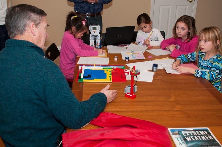 Mike Dillabough, San Francisco District chief of Operations and Readiness, talks to members of the Junior First Lego League Team "Robopeople" about flood risk management Dec. 14.