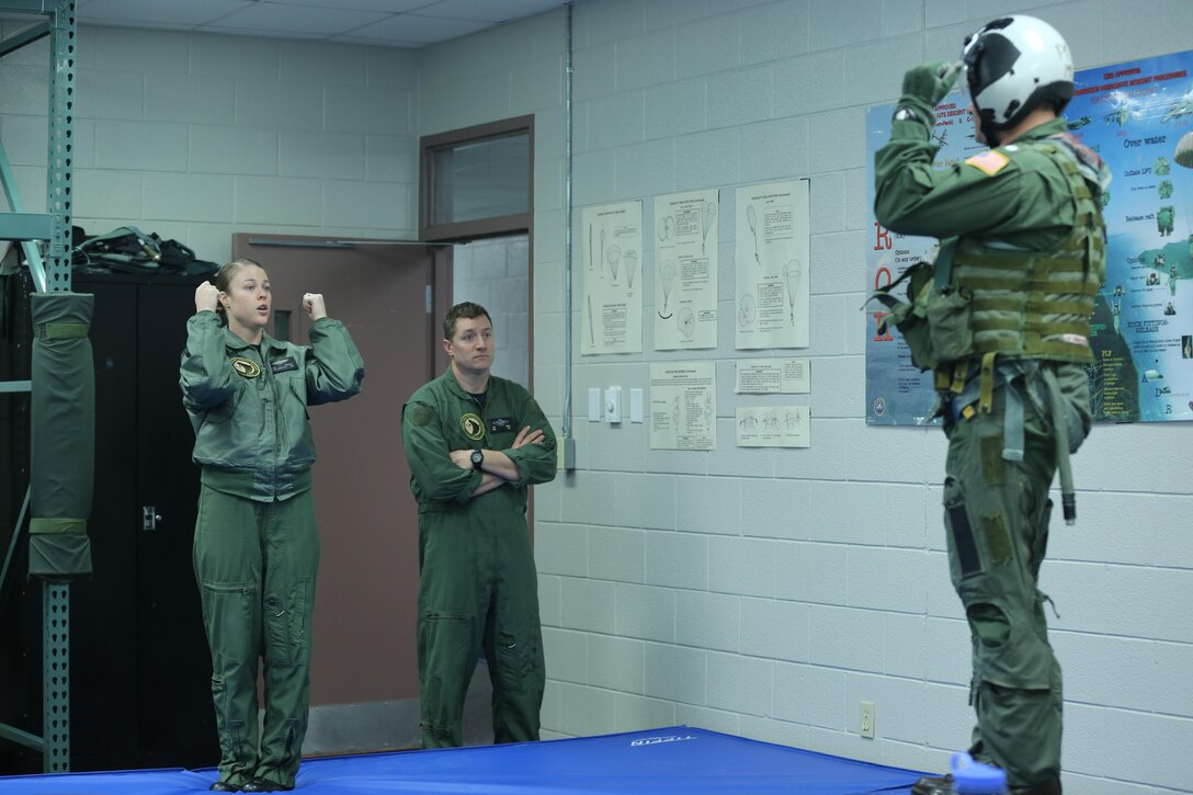 Cmdr. Rick “Dolp” Bestgen (right) receives instruction on the proper technique for landing on the ground during an emergency during survival training at Marine Corps Air Station Cherry Point’s Aviation Survival Training Center Jan. 22. All naval aviators conduct refresher training every four years to remain ready to support possible future operations and training.