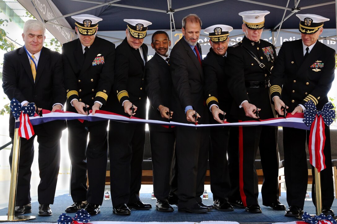 From left to right: Richard Heim, Rear Adm. Douglas G. Morton, Rear Adm. C. Forrest Faison III, Hon. Jonathan Woodson, Hon. Mike McCord, Rear Adm. Bruce L. Gillingham, Lt. Gen. John A. Toolan and Capt. Mark A. Kobelja simultaneously cut the ribbon during the dedication and ribbon cutting ceremony at the replacement facility Naval Hospital Camp Pendleton Jan. 31. The ceremony was held to officially open the 500,000-square-foot, four-story building. Heim is the president and chief executive officer of Western Region Clark Construction Group-Calif., LP. Morton is commander of Naval Facilities Engineering Command, Atlantic. Faison is the deputy surgeon general of the Navy and deputy chief for the Bureau of Medicine. Woodson is the assistant Secretary of Defense for Health Affairs. McCord is the principal deputy under Secretary of Defense (Comptroller). Gillingham is the commander of Navy Medicine West at the Naval Medical Center San Diego. Toolan is the commanding general of I Marine Expeditionary Force. Kobelja is the commanding officer of Naval Hospital Camp Pendleton.