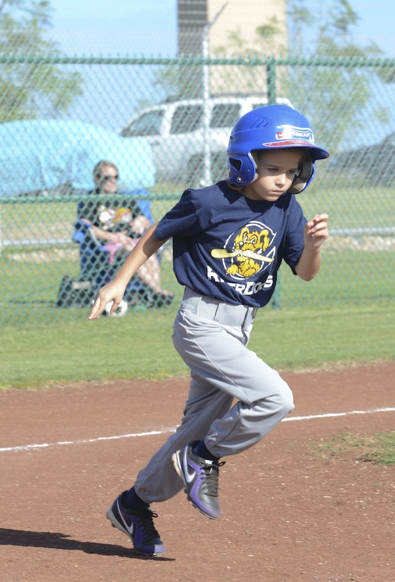 Joint Base Pearl Harbor-Hickam RiverDog Magena Baker, 7, runs for first base after getting a hit during a youth baseball game at C Street Field, Jan. 25, 2014. The K-Bay River Bandits defeated the Joint Base Pearl Harbor-Hickam RiverDogs, 15-11, aboard Marine Corps Base Hawaii. Both teams belong to the Pinto age division of youth baseball. (U.S. Marine Corps photo by Kristen Wong)