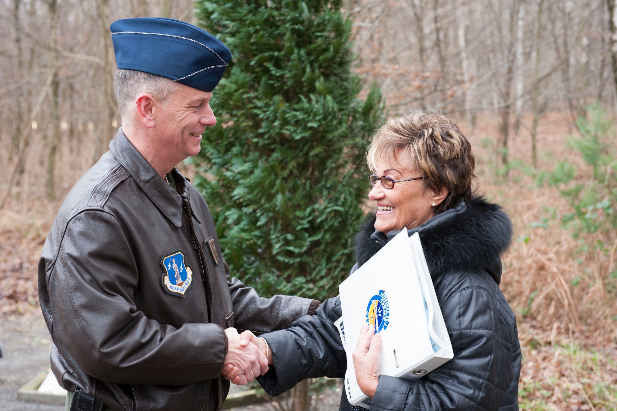 U.S. Air National Guard Col. Daniel J. Swain, commander of the 141st Air Refueling Wing, thanks Else Kriska for the care she has provided to the erected memorial honoring the crew of "ESSO 77" over the last 15 years in Geilenkirchen, Germany Jan. 9, 2014.. The memorial pays tribute to four 141st Air Refueling Wing Airmen who lost their lives in a KC-135E Stratotanker crash  Jan. 13, 1999.