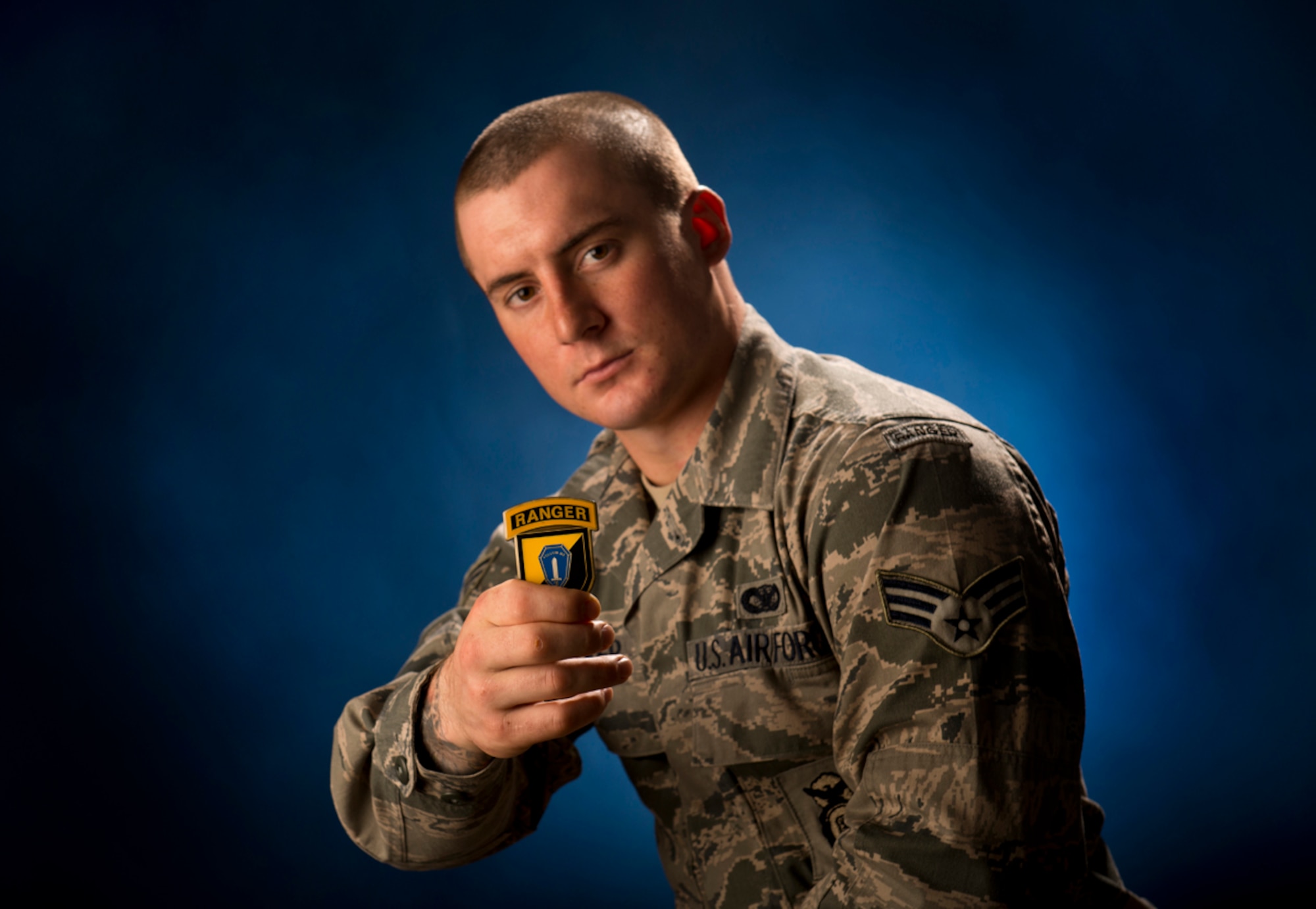 Senior Airman Stephen Becker, a native of Minerva, Ohio, holds a U.S.
Army Ranger School commander's coin Jan. 31, 2014, at Joint Base
Elmendorf-Richardson, Alaska. Becker is the 257th Airman to graduate from the U.S. Army Ranger School at Ft. Benning, Ga. The purpose of the school is to develop combat skills of selected officers and enlisted men by requiring them to perform effectively as small unit leaders in a realistic tactical environment, under mental and physical stress approaching that found in actual combat. (U.S. Air Force photo/Justin Connaher)