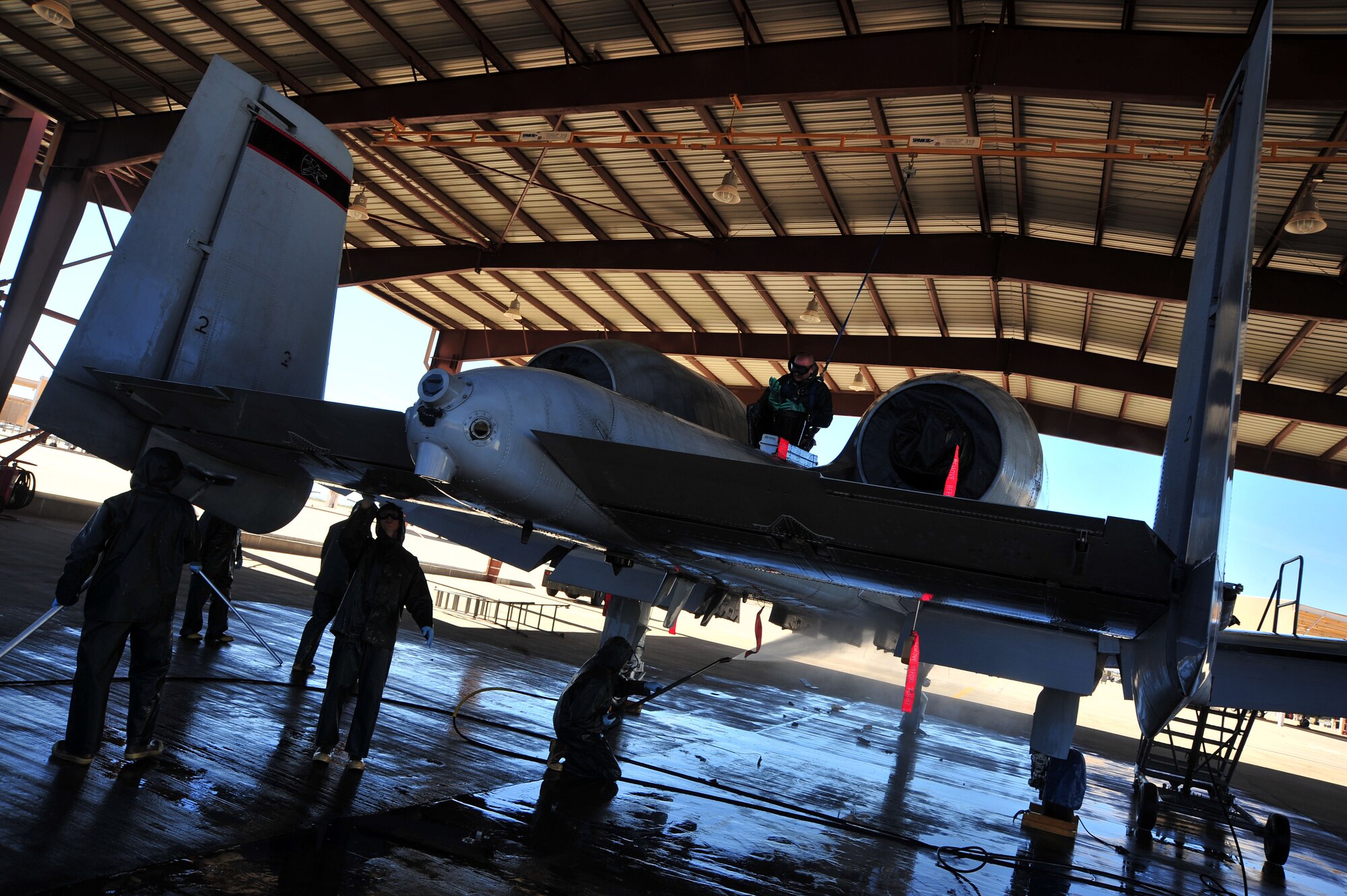 The 355th Aircraft Maintenance Squadron leadership work with their Airmen to wash an A-10C Thunderbolt at Davis-Monthan Air Force Base, Ariz., Jan. 28, 2014.  The Airmen use pressure washers with more than 3,000 pounds of pressure per square inch to clean the aircraft. (U.S. Air Force photo by Senior Airman Josh Slavin/released)