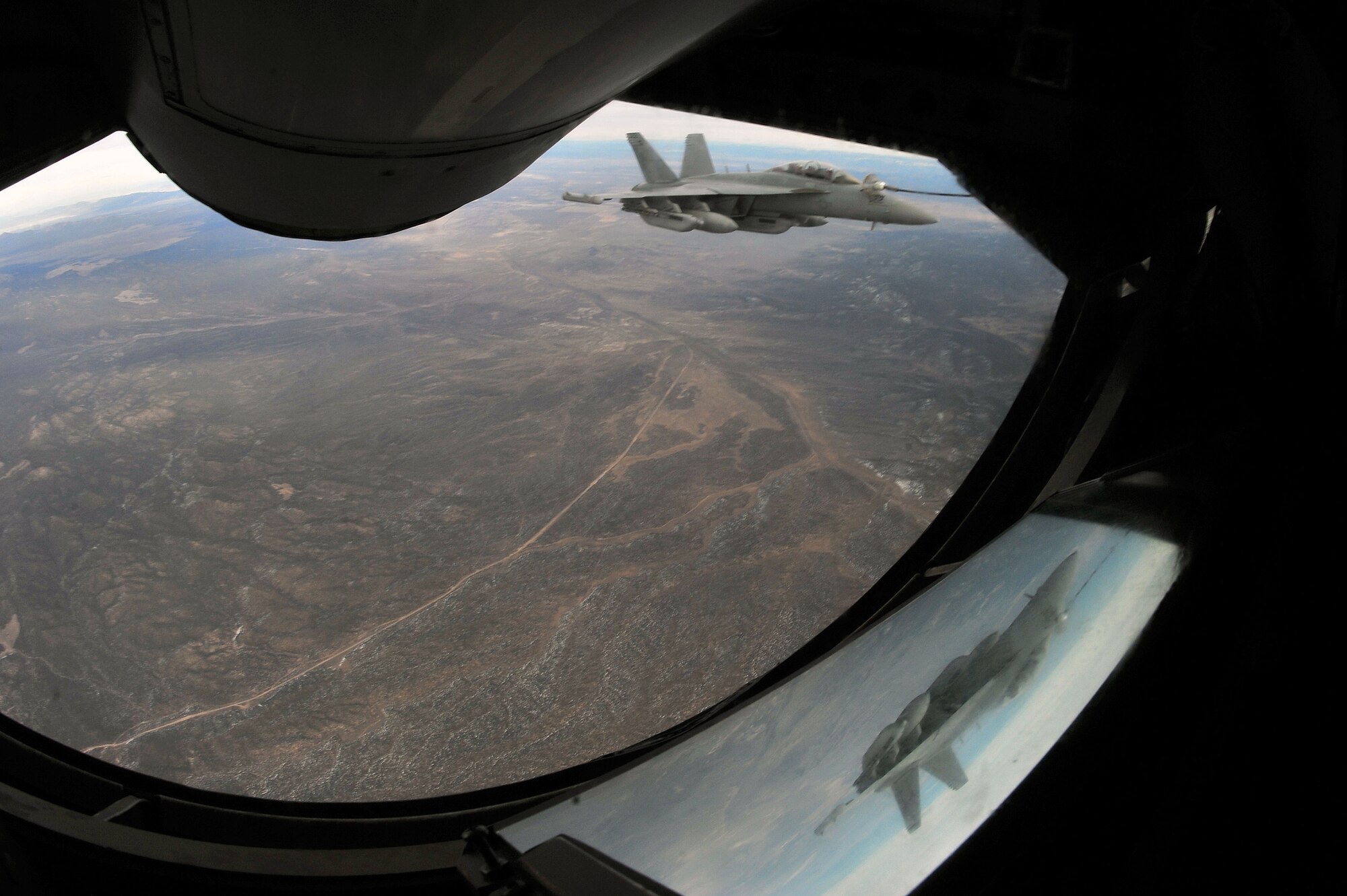 An EA-18G Growler from Naval Air Station Whidbey Island, Wash., is refueled by a KC-135 Stratotanker from Fairchild Air Force Base, Wash., during Red Flag 14-1 Jan. 29, 2014, over the Nevada Test and training Range. Red Flag has expanded to incorporate all spectrums of warfare to include command and control, real-time intelligence, analysis and exploitation, and electronic warfare. (U.S. Air Force photo by Staff Sgt. Veronica Montes/Released) 