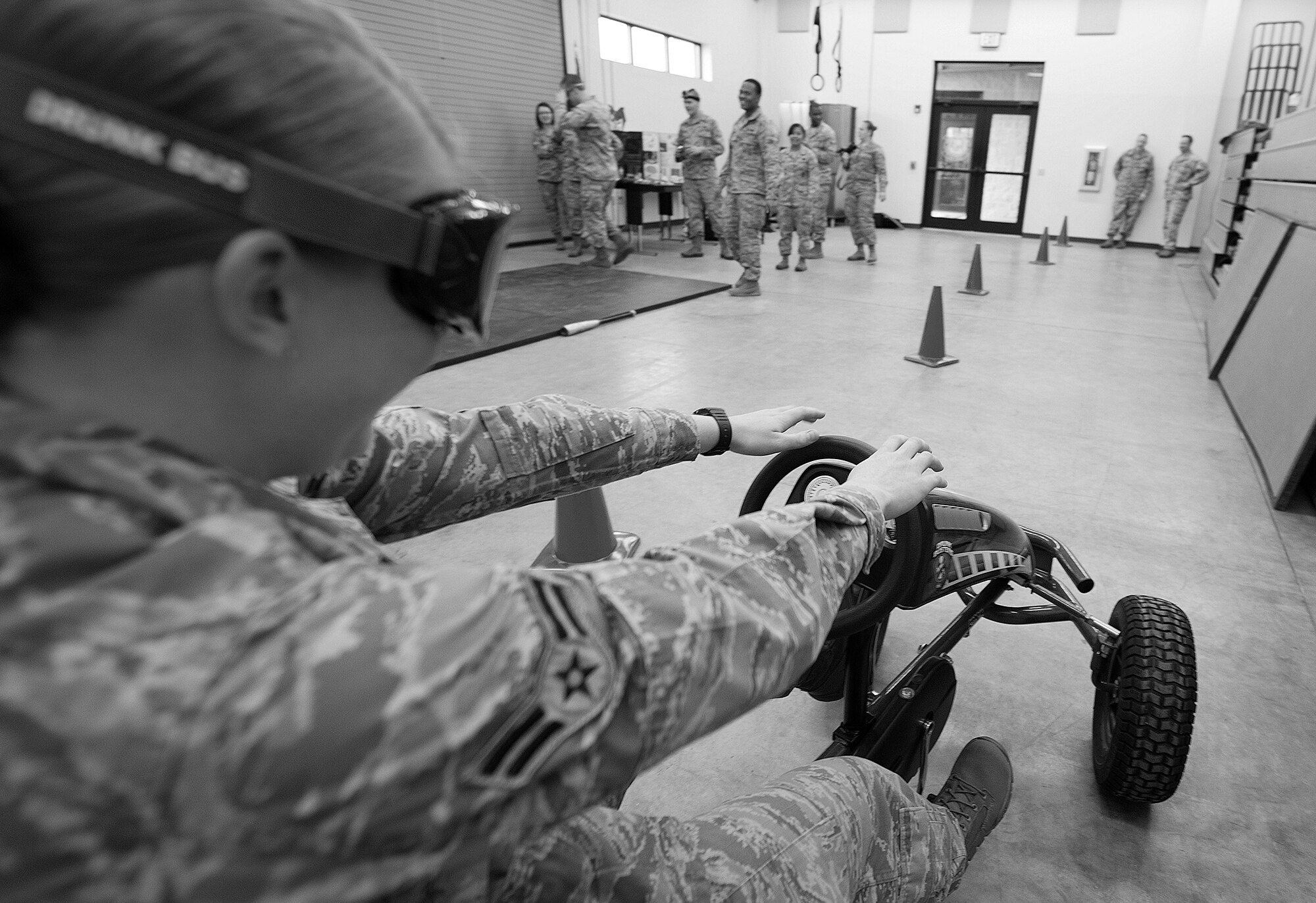 U.S. Air Force Airman 1st Jenny Walker, 823d Base Defense Squadron fire team member, drives a pedal cart wearing “drunk goggles” during an Alcohol Drug Abuse Prevention and Treatment demonstration at Moody Air Force Base, Ga., Jan. 31, 2014. Airmen took turns maneuvering the course while wearing the vision-impairing goggles. The visibility through the goggles was equivalent to someone’s vision with a blood alcohol content level ranging from .04 to .25. (U.S. Air Force photo by Senior Airman Tiffany M. Grigg/Released)