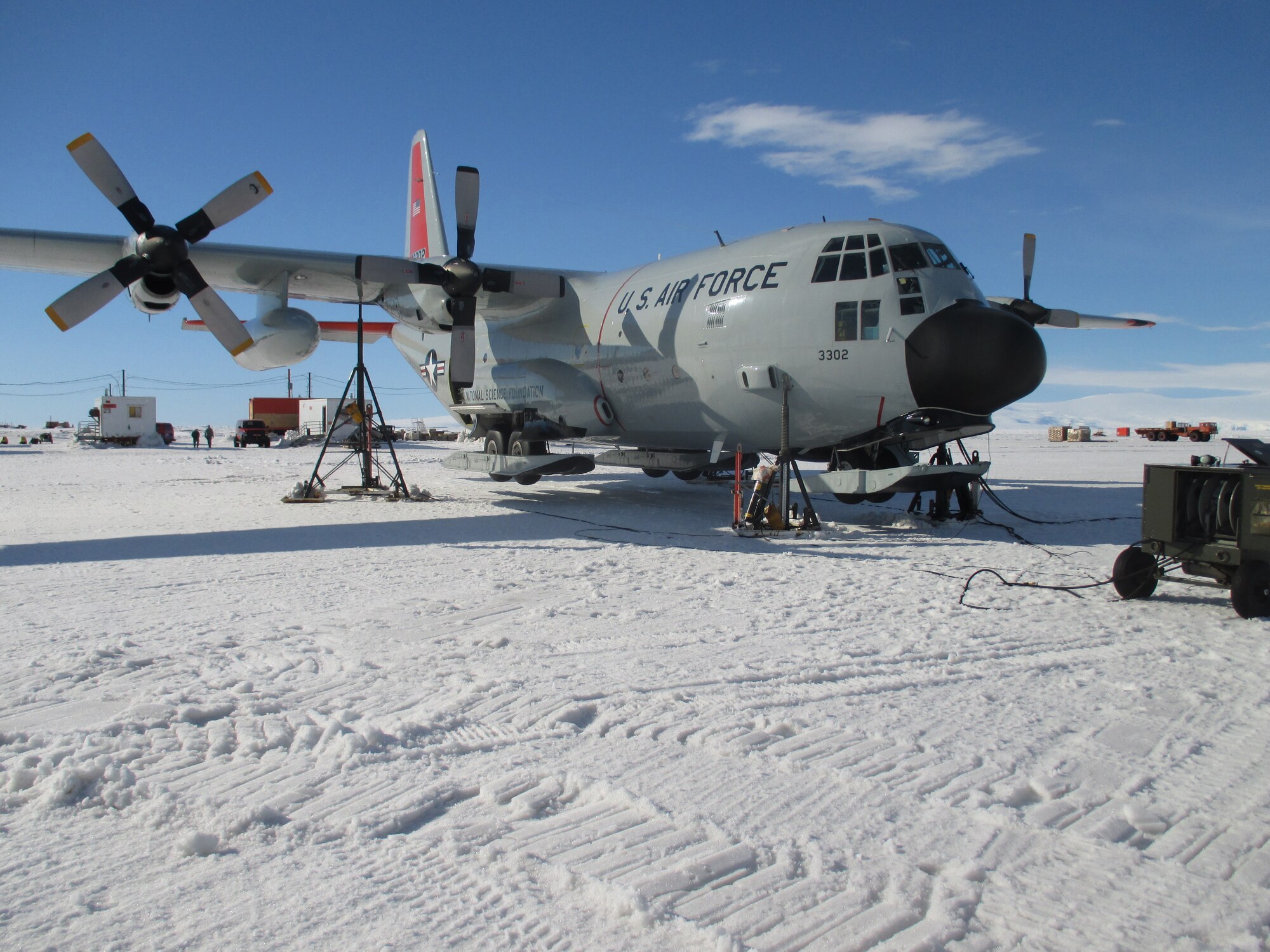 Pegasus Field, Antarctica - An LC-130 Skibird from the New York Air National Guard is jacked up on the frozen ice shelf of Pegasus field 16 Jan 2014 after aircrew discovered a landing gear issue.  The maintenance crews of the 109th Airlift Wing do not have hangars to work out of while deployed to Antarctica for Operation DEEP FREEZE and must work in the elements and handle unique challenges nearly every day.  (U.S. Air National Guard photo by Master Sgt. Kevin Phillips/Released)      