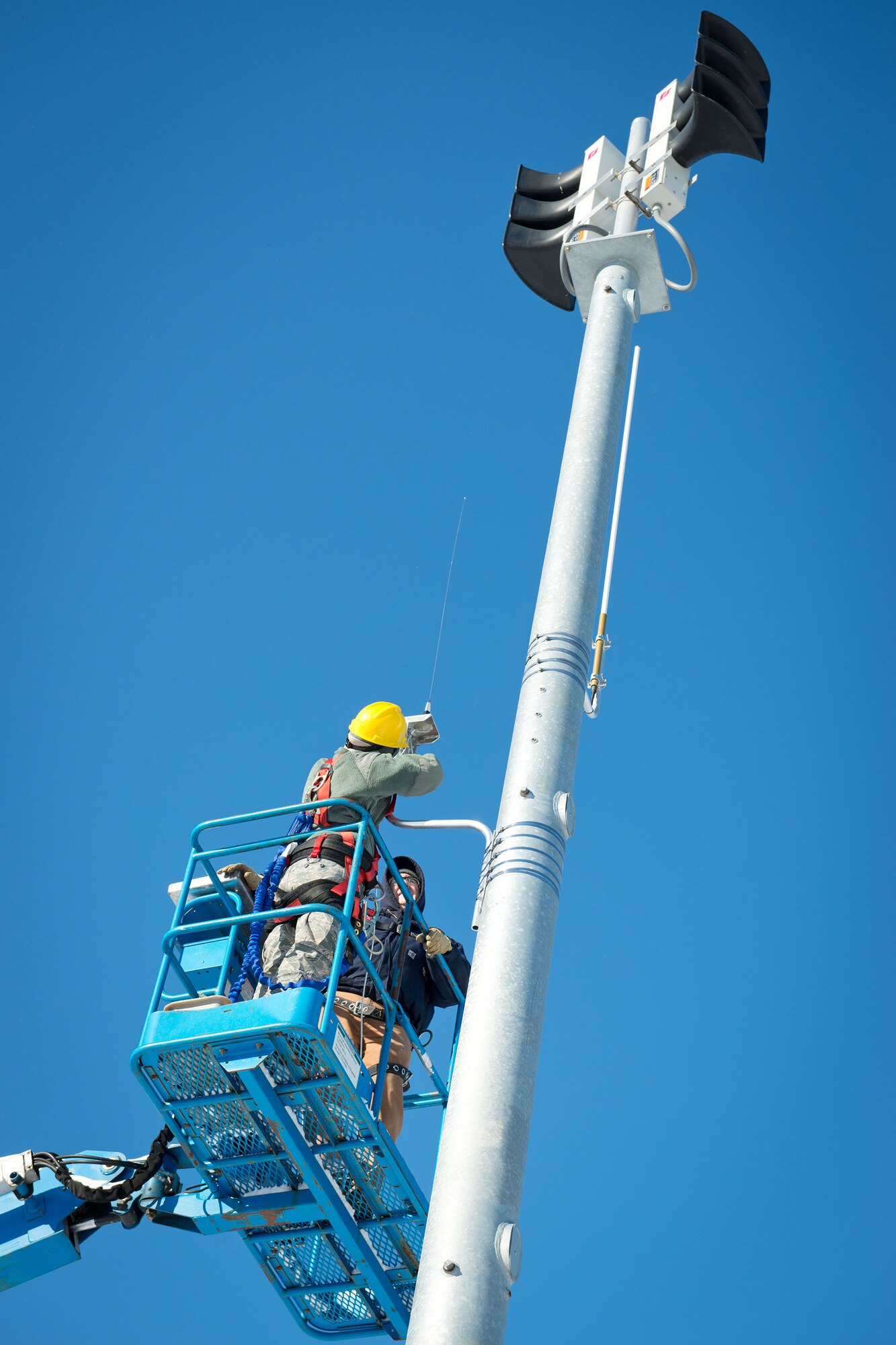 Members of the 934th and 133rd Airlift Wings install a new interface to the Minneapolis-St. Paul Air Reserve Station's giant voice that will allow Hennepin County to also broadcast emergency updates on base.  (U.S. Air Force photo by Paul Zadach/Released)