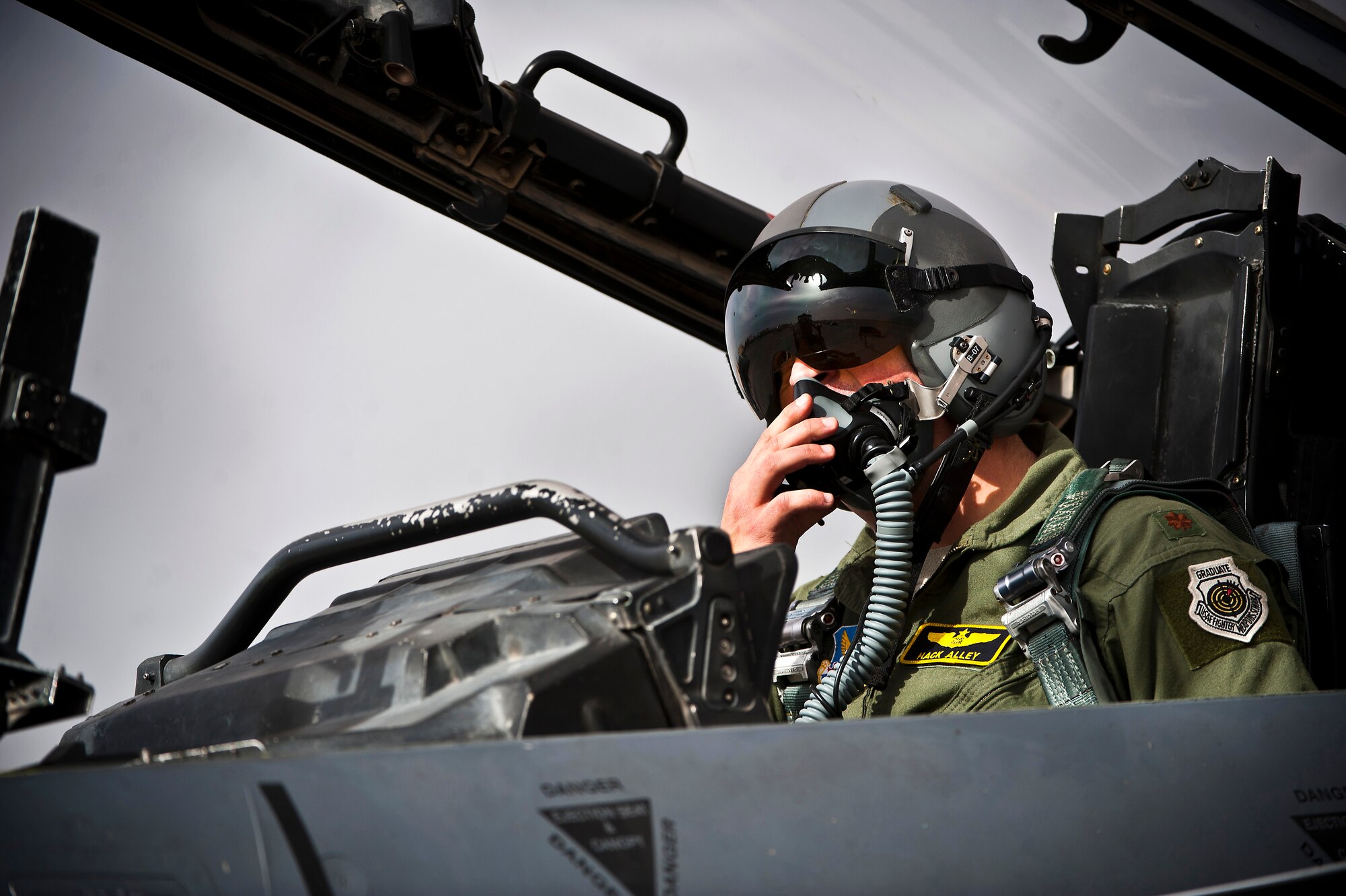 U.S. Air Force Maj. Christopher Alley, 391st Fighter Squadron F-15E Strike Eagle weapons systems officer, Mountain Home Air Force Base, Idaho, conducts preflight checks inside his aircraft during Red Flag 14-1 Jan. 30, 2014, at Nellis AFB, Nev. Red Flag provides realistic combat training in a contested, degraded and operationally limited environment. This provides pilots with real-time war scenarios and helps their ground crews also test their readiness capabilities. (U.S. Air Force photo/Senior Airman Brett Clashman)